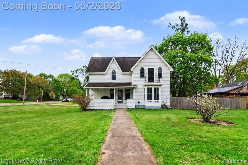 Step back in time with this beautifully preserved historic gem-the third home built in Grand Ledge! Situated on a spacious corner lot of over half an acre, this propoerty blends timeless character with modern updates. The main level features a brand new kitchen with granite counertops, new cabinetry, and all stainless steel appliances, perfectly complementing the home's historic charm, along with original hardwood flooring throughout the main floor. Origianal features remain intact, including a stunning fireplace that serves as the focal point of the dining room. You'll also find first floor laundry, a bedroom, and a full bath-ideal for flexible living. Upstairs offers an expansve primary bedroom with a brand new balcony and a walk in closet, along with two oversized bedrooms with very large closets. A versatile flex room and loft provide endless possibilities for office space, playroom, or addititonal living area. Enjoy the fenced-in backyard, plus a 2-car garage with attached carport and a walk up attic above for extra storage or future potential. A rare opportunity to own a piece of Grand Ledge  history. Sellers have invested over $100,000 in the last 2 years. Entire interior stripped to studs, drywalled, painted, stained, trim, new stub floors throughout upstairs with LVP installed, new balcony, complete bathroom upstairs with refurbished tub, added 1/2 bath and 1st floor laundry, walls and attic blown in insulation, new $20,000 boiler, added pitched roof by kitchen entrance and had original doors sanded and stained. Exclude TV and freezer.