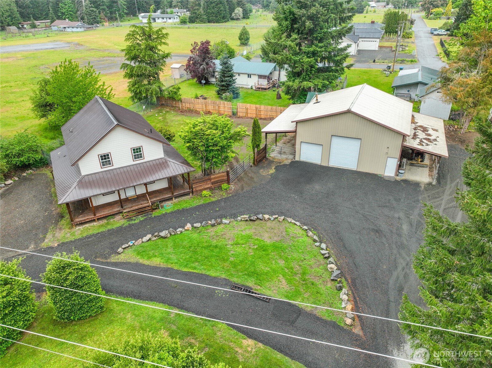 Need room for toys, tools, RVs, and mountain lifestyle? This refreshed Packwood property offers something increasingly hard to find—a move-in-ready home paired with a massive 36x36 shop with loft, ¾ bath, and two 12x36 covered lean-tos. Set on over  half an acre with loop driveway and abundant parking, there’s room here for the equipment, hobbies, and adventures that make mountain living fun.   Inside, the home is bright, open, and inviting, with abundant natural light and plenty of room to gather. The kitchen has been refreshed with new counters, updated appliances, and stylish flooring. Vaulted ceilings and a loft add character and openness, while the full wraparound porch extends the living space outdoors—the perfect place for coffee, dinners, or simply taking in the mountain setting.  The real standout is the shop. With a 1,296-sqft footprint and an additional 864 sqft of covered lean-to space, it offers exceptional room for recreational equipment, workshop, storage, etc. With a 3-bedroom septic already serving the property, explore additional possibilities for property use.  Outside, enjoy a spacious backyard, partial views of Mt. Rainier, and plenty of space to spread out. Located just a few blocks from downtown Packwood and within easy reach of White Pass Ski Area and Mt. Rainier National Park, making it an ideal home base for year-round recreation. More than a mountain getaway, this is a property built for those who need space to actually live the mountain lifestyle.