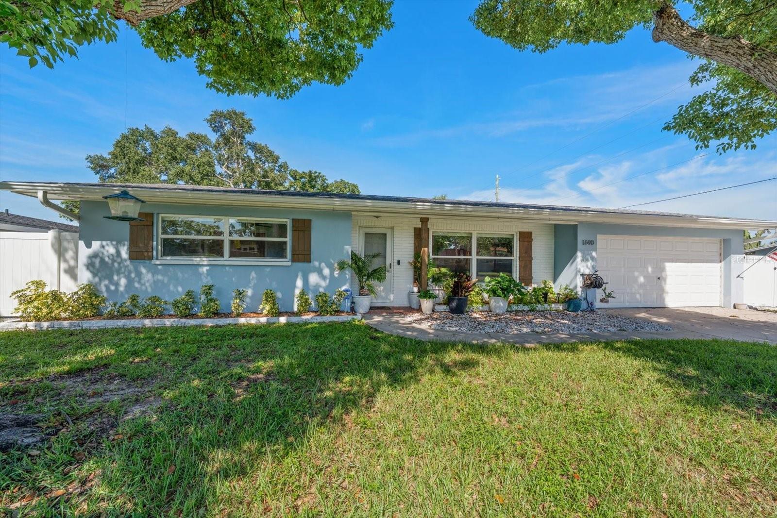 Welcome to 1690 Pinehurst, where classic Dunedin character meets thoughtful updates and an easygoing Florida lifestyle. This spacious 3 Bedroom, 2 Bathroom offers a versatile den, Open Layout with split plan and formal primary suite!  Updates include beautiful terrazzo flooring, new windows, roof 2020, HVAC 2022, vinyl fence and solar panels for added energy efficiency. The updated kitchen shines with granite countertops, white shaker cabinets, newer appliances and breakfast bar ready for everything from morning coffee to weekend entertaining. Storage and flexibility abound with an oversized laundry and storage area, a 2 car garage, and a backyard shed. A double gate provides convenient access for boat or recreational-vehicle parking. After a day on the water, unwind on the patio, gather around the fire pit, and enjoy relaxed evenings under the Florida sky. Or take your Golf Cart (Zoned for recreational Golf Cart Use) beyond the property, Dunedin offers a lifestyle all its own. Explore its walkable downtown filled with locally owned restaurants, craft breweries, boutiques, galleries, markets, concerts, and year round festivals. Enjoy miles of recreation along the Pinellas Trail, discover the abundant city parks, stroll waterfront favorites such as Edgewater and Weaver Parks, or spend the day fishing, paddling, and soaking up the sun along the Dunedin Causeway and Honeymoon Island. This home has the perfect setup for many gatherings, hobbies, toys, and moments that make a house feel like home. Come experience the space, character, and unmistakable Dunedin charm for yourself!  The location cannot be beat!