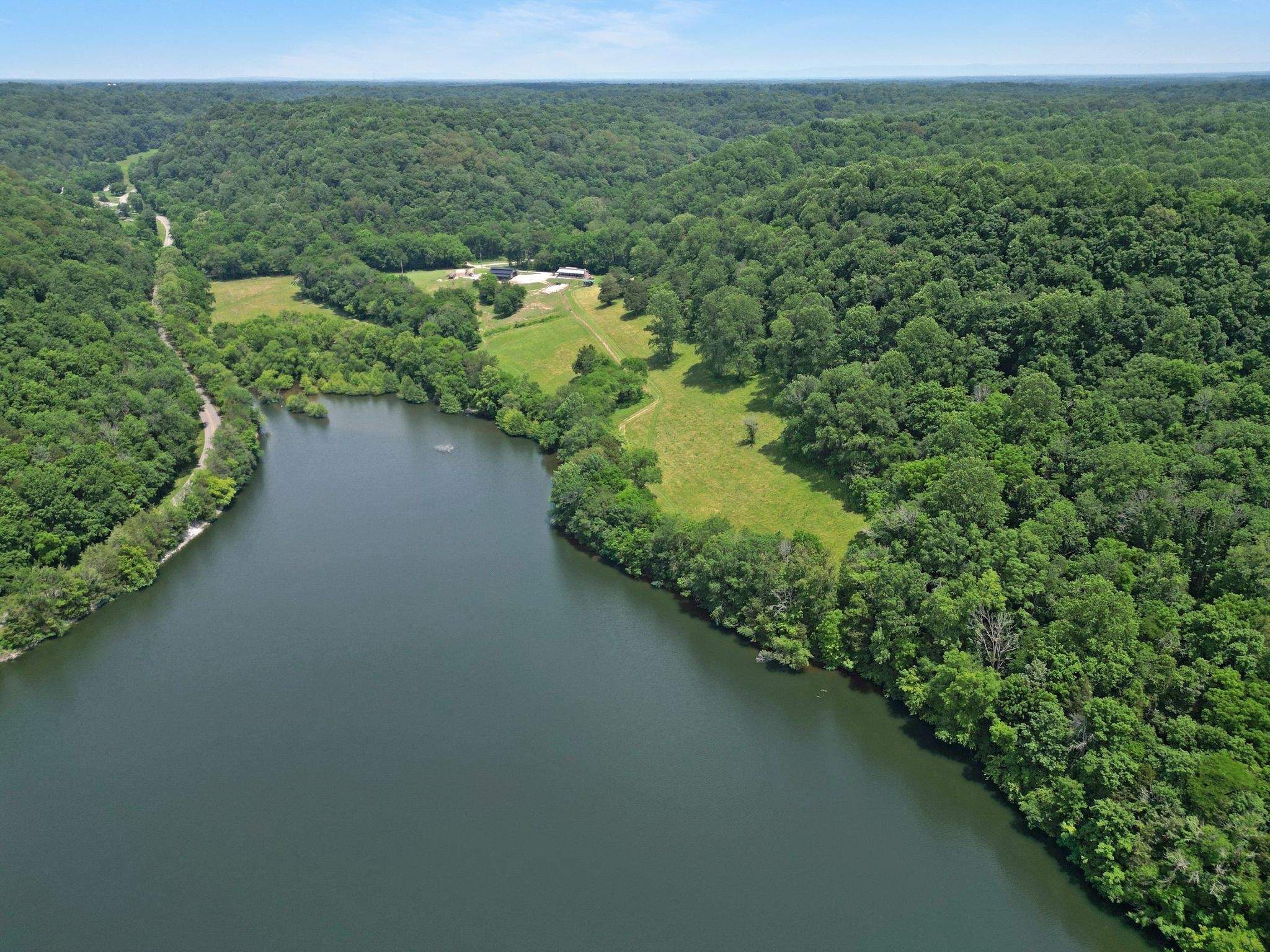 Lake, Equestrian, Nature Lover’s Paradise – 49.62 Acres of Secluded Beauty. Discover a truly unique retreat tucked away in a picturesque valley surrounded by the tranquil waters of Normandy Lake in the hills of Tennessee.  This 49.62-acre with an extra 20 acres of agriculture lease with TVA  haven offers complete privacy, over 2000 ft of lake and creek frontage, some of which is seasonal-perfect for those who crave connection with nature. Charming Lake Cottage with a stone wood burning fireplace and spacious covered porch, ideal for relaxing and enjoying panoramic views. This beautifully decorated and modern cottage is perfect to live in or to use as a guest house after you build your dream home. Granite countertops and custom cabinets in kitchen, granite gas log fireplace in living room. Mature hardwoods and valuable timber, creating a lush, wooded landscape teeming with wildlife. Horse, hiking, and ATV trails, winding through scenic terrain. Equestrian facilities, including a 36x48 four-stall barn with a hayloft, automatic self-waterers in all 3 pastures, cross-fenced pastures with solar fencing and year-round grazing. A newly built 40x60 equipment barn offers ample space for tools, gear, and storage.This is a complete setup for the serious equestrian or anyone seeking peace, privacy, and a lifestyle immersed in natural beauty. Whether you’re riding through your own trails, fishing off the lakefront, or watching deer graze at sunset, this property is the perfect escape! No restrictions. Parcel ID # 070 008.00(23.42acres) & Parcel ID# 070 008.03(26.2 acres) are being sold together for total of 49.62 acres. Greenbelt.