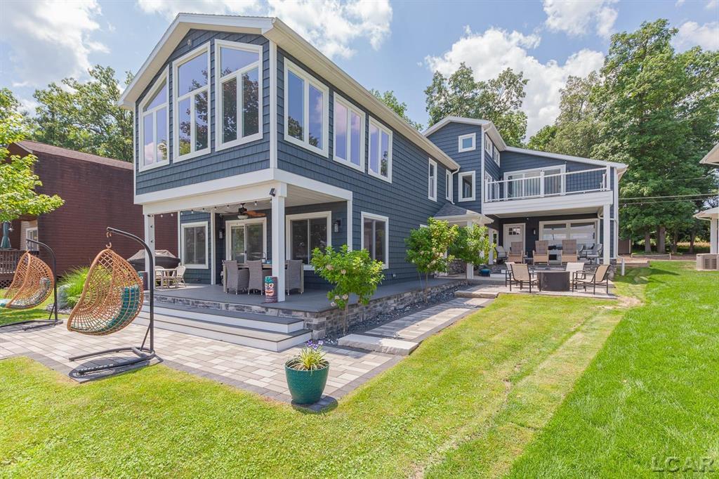 Discover your dream lakeside retreat! This stunning compound boasts nearly 3000 square feet of living space, featuring 5 spacious bedrooms and 2 cozy sleeping lofts, including a large first-floor bedroom for easy access. The luxurious primary suite is a true sanctuary, complete with a spa-like bathroom, two walk-in closets, and a private balcony perfect for enjoying breathtaking sunrises. Step outside to an incredible outdoor living area, featuring covered decks, a patio, a firepit, and a garage with tandem doors ideal for parking or entertaining. Plus, the additional backlot offers ample space for parking or the potential for a future carriage house or garage. Embrace lakeside living at its finest!