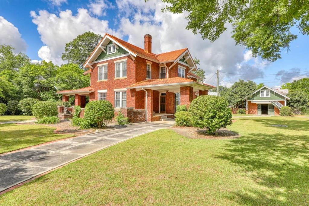 OPEN HOUSE SATURDAY MARCH 21 FROM 2-5 PM.  A Rare Historic Masterpiece in the Heart of Moultrie Welcome to 902 2nd Street SE, an exceptional offering in Moultrie's rich architectural landscape. Thought to be the work of renowned architect Solomon Andrew Layton—the visionary behind the Oklahoma State Capitol—this 1912 brick residence is a striking example of early 20th-century design and craftsmanship. Spanning over 4,100 square feet on a generous 0.62-acre lot, this 3-bedroom, 2.5-bath home blends grandeur with livability. Period details abound: hardwood floors, vintage tilework, detailed millwork, ornate fireplaces, and classic light fixtures—each a testament to the enduring quality and refined elegance of its era.  The home's exterior is equally distinguished, featuring solid red brick construction, a terracotta tile roof, porte-cochere, and a detached garage built for Moultrie's very first automobile. This garage would also make a beautiful guest home. Mature landscaping surrounds the property, offering privacy and a sense of timeless serenity. The expansive unfinished attic provides opportunity for additional living space, creative use, or extensive storage. Located just a short stroll from Moultrie's charming downtown, this property offers the rare chance to own a legacy. Homes of this caliber—and historical provenance—rarely come to market. Whether you're an architecture enthusiast, a preservation-minded homeowner, or a buyer seeking something extraordinary, 902 2nd Street SE is a once-in-a-generation opportunity to steward one of South Georgia's architectural treasures.  The owner is a licensed agent in another state.