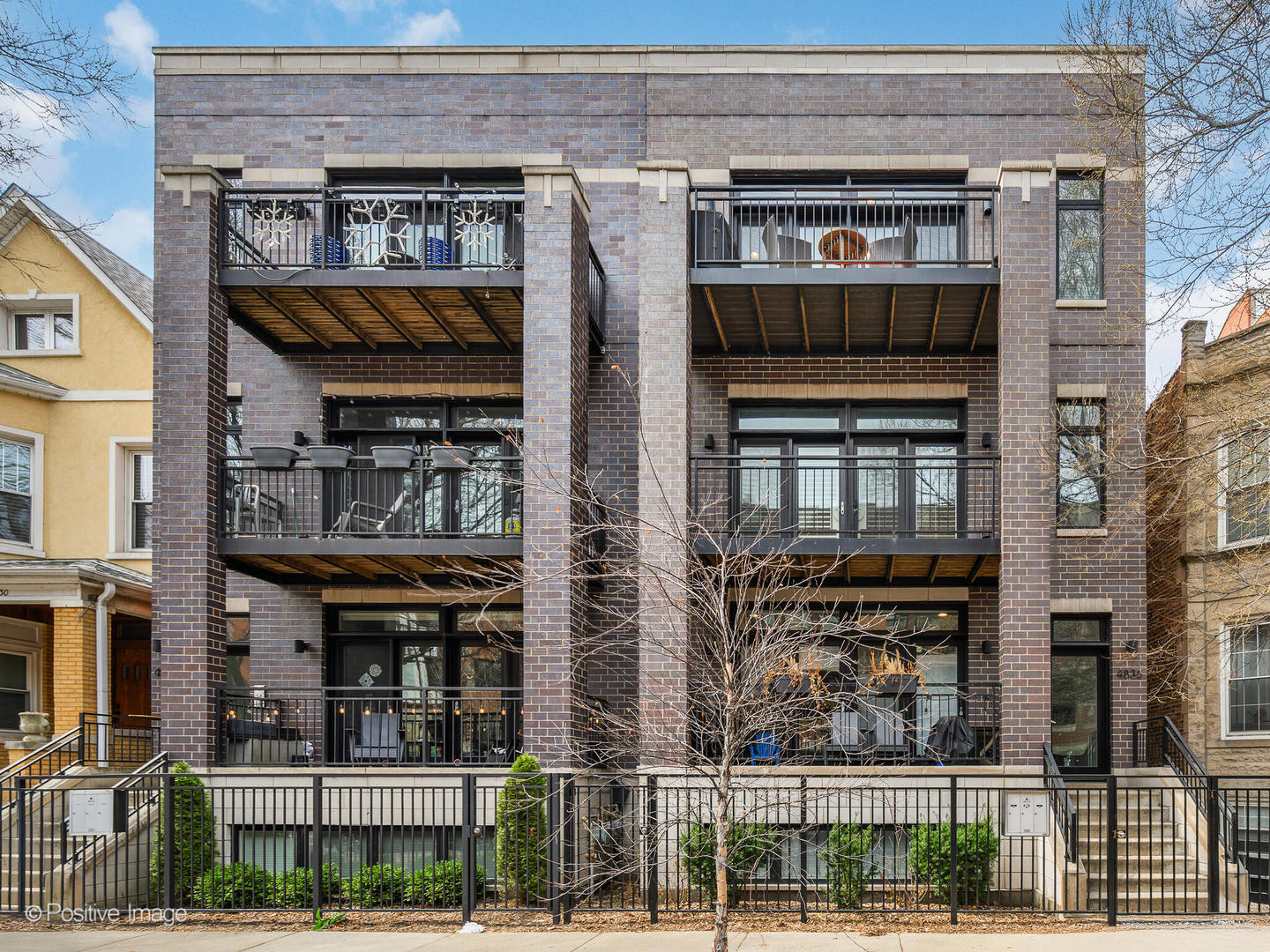 Nestled in the heart of Ravenswood, this beautiful, extra-wide penthouse condo offers an exceptional blend of style, comfort, and outdoor living, with abundant natural light, hardwood floors, and designer finishes throughout. The open-concept living and dining area is enhanced by a sleek fireplace surrounded by custom built-ins and room for six-person dining. The kitchen impresses with ample cabinetry, a large island with seating for four, and stainless steel appliances. Enjoy seamless indoor/outdoor living with the first of three private outdoor spaces-a roomy front balcony, updated with Trex decking, that runs almost the full length of the building. The spacious primary suite boasts a walk-in closet and direct access to the second private outdoor space-a rear balcony, also updated with Trex decking. The ensuite bath offers a true retreat with a dual vanity, marble finishes, a soaking tub, and a separate walk-in shower with body sprays. Two additional bedrooms provide versatility to suit your living needs. A true standout is the third outdoor space-an expansive rooftop deck, fully upgraded with Trex decking, new railings, and a pergola-perfect for entertaining. A wet bar on the top floor makes hosting effortless. Additional highlights include extra storage and an end-unit garage parking space. Conveniently located near the Damen Brown Line, Ravenswood Metra, Winnemac Park, and all that Ravenswood and Lincoln Square have to offer, this home is a must-see!