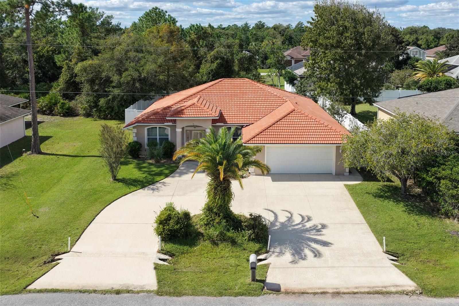 Discover this inviting 3-Bedroom, 2 bath split floor plan home located in the sought-after F section of Palm Coast, featuring a durable tile roof, and a convenient circular driveway-this property offers an attractive curb appeal and plenty of parking. Step inside to an open and airy living and dining area, creating a welcoming space for everyday living and entertaining. The large kitchen features granite countertops, plenty of cabinets and counterspace, provides an attractive setting for preparing meals and gathering with family and friends. An inside laundry room adds convenience to your daily routine. The spacious primary suite offers a comfortable private retreat, complete with generous his-and-her closets and an ensuite bathroom featuring a relaxing jacuzzi tub, separate walk-in shower, double sinks, and a private water closet. Additional highlights include a spacious kitchen nook; Enjoy the Florida lifestyle from the tiled and screened-in back porch with pre-plumbing for a summer kitchen, is perfect for relaxing and enjoying the outdoors; a good size storage room built into the main house; the fenced backyard provides additional outdoor space to enjoy. Enjoyed as a vacation home and only occasionally occupied, this property offers a wonderful potential as a full time residence, seasonal retreat or as an investment opportunity, this home is ready for it's next chapter. Convenient access to shopping, dining, parks, Palm Harbor golf courses and the beautiful beaches of Flagler County. Near by walking / jogging trails. Quick access to 1-95. Don't miss the opportunity to make this home your own!