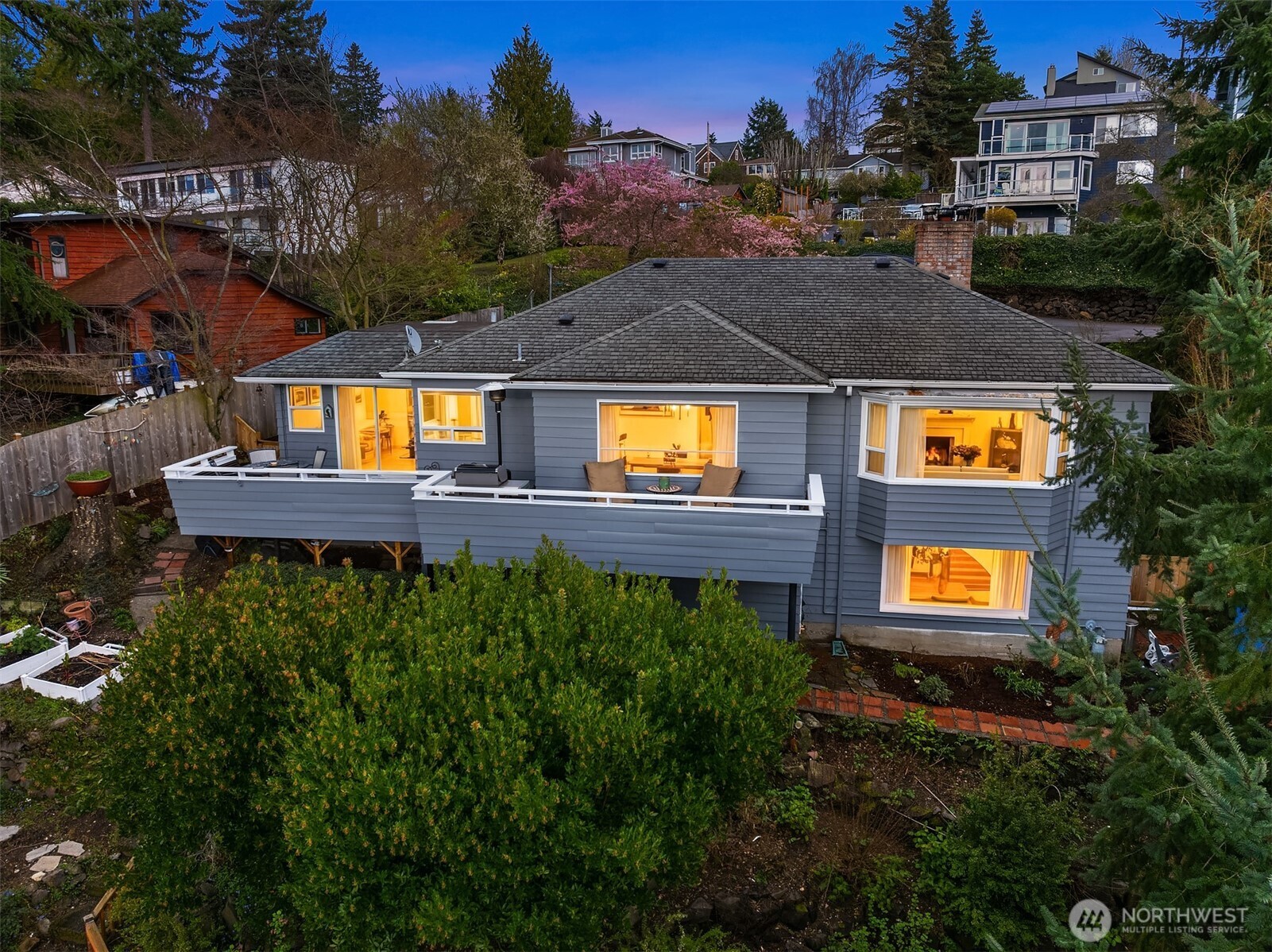 MOTIVATED SELLER - BRING OFFERS ON THIS WONDERFUL HOME. Beautiful and Serene Three Tree Point VIEW HOME.    Set high among aromatic evergreens, this treetop refuge feels suspended between earth and sky. Built in 1939, its architecture blends traditional, craftsman, and mid-century influences—a home that has collected eras the way travelers collect stories.    Here, the line between home and nature blurs. Eagles drift past and seabirds trace arcs against a backdrop of mountains and shimmering water. From the bay windows and deck, the sun melts into the horizon, trees catching the light and scattering it in colorful streaks. The landscape feels both wild and lovingly tended—fig and apple trees mingle with raspberries, elderberries, & clusters of champagne grapes, a quiet garden orchestra that hums with life.    Reaching the home means following a private drive that feels like a gentle retreat from the world. Yet shops, restaurants, & the airport remain close enough to be convenient—far enough to leave the tranquility untouched.    Inside, the home bursts with character. Built-in shelving and cabinetry curve into the walls, ready to hold books, art, & keepsakes. Downstairs, a unique arched, cove-style fireplace anchors the main room, radiating warmth that feels both literal and nostalgic.    This is more than a house—it's a perch above the shore, a front-row seat to the quiet theater of sky, sea, and forest. A timeless retreat where modern life pauses and nature steals the show.