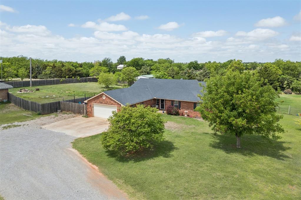 Set on a beautifully quiet 1-acre, this spacious and character-rich home offers room to live, work, and entertain with ease. Featuring 4 bedrooms and 2.5 baths, the layout is both functional and inviting, ideal for hosting guests or enjoying everyday living. A welcoming entryway opens into a lovely step-down living room with elevated ceilings, canned lighting, and gas log fireplace with a handsome wood mantle, built-ins and cabinetry add both charm and functionality. The kitchen is thoughtfully designed with quartz countertops, a built-in glass-top stove with hood vent, oven, microwave, vibrant Mexican Talavera tile backsplash, and plenty of cabinet space. Just off the kitchen is a well-appointed laundry room featuring cabinets, a countertop, sink, space for a second refrigerator, and a convenient half bath. A large dining room filled with natural light creates an inviting space for gatherings. The private office, complete with French doors, wood paneling, tile flooring, making it an ideal workspace. The spacious master suite offers a raised ceiling, crown molding, and a walk-in closet with built-ins. The en-suite bathroom includes a double vanity with mirror cabinets, a Jacuzzi tub, and separate shower. Additional features include a large concrete basement/storm shelter, painted concrete flooring in select areas, security windows, unique light fixtures, and ceiling fans in every room. The home also boasts new carpet, a 2019 high-impact roof, and updated HVAC(American Standard heat pump) replaced in 2019. A NEW Rheem water heater installed in 2026 adds to the home’s efficiency. The outdoor amenities further enhance the property, including a chicken coop, a 20x22 barn with power line already run (not yet connected), electric fencing for dogs, and four gated entry points. With the added advantage of an assumable 3.25% loan, this home offers a rare combination of peaceful space, versatility, and unique character, making it a standout opportunity.