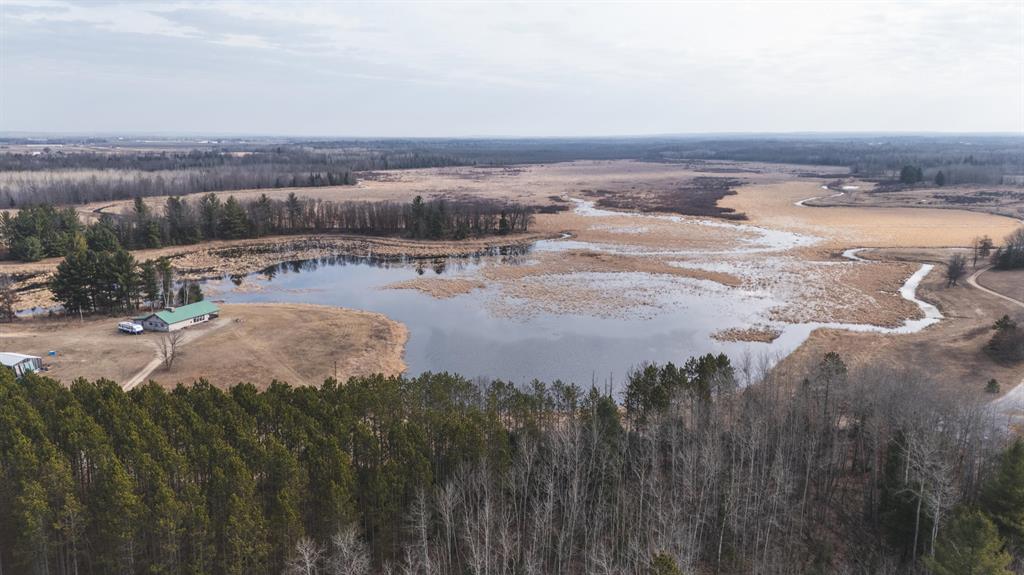 How does a 60+/- acre lake teaming with ducks, lots of ducks, and lots of geese sound? How about 1340+/-/- acres of untouched deer woods with 60-70 acres of prime food plots ready to hunt? Too many rubs and scrapes to count literally... hundreds of them. Trees shredded from your chest to the ground. It sounds a bit far-fetched, but we can show it to you. The property has been hunted with very low pressure for the past five years, with several deer in the high 140s and low 150s taken. I'm telling you I have been on hundreds of hunting properties in the past 9 years and have never seen anything like this one.

On our first drive through the property, we saw well over 60 deer and found 6 shed antlers lying in one food plot. I can't imagine what must be in and around the bedding areas. Deer trails are like cattle trails and are everywhere. The waterfowl hunting is equally amazing with one permanent duck blind, but more portables can be used anywhere. We walked up to a chunk of flooded timber and blew up 10+ wood ducks and too many mallards to count, not to mention the geese all over the water. The lake is 100% controllable; it can be flooded for waterfowl season, then drained down for deer season. We are told that during the rut, when the lake is drained, several bucks can be seen chasing does in the high grass where the lake was. In short, this may be one of Michigan's best deer and waterfowl hunting properties, and we don't say that lightly. The road/trail systems on the property have been very well maintained and are in excellent condition. All the food plots, stands, and blinds can be easily reached. This property will make someone a true hunting and recreational paradise, or perhaps you and your hunting buddies want to partner in a property. This is the perfect property for that. The cabin on the parcel sleeps a minimum of 8 with room for more. The 15-foot giant real stone fireplace offers a great place to share the stories from a day or enjoy a cocktail after the hunt. Call us today at 989-600-4112 to schedule