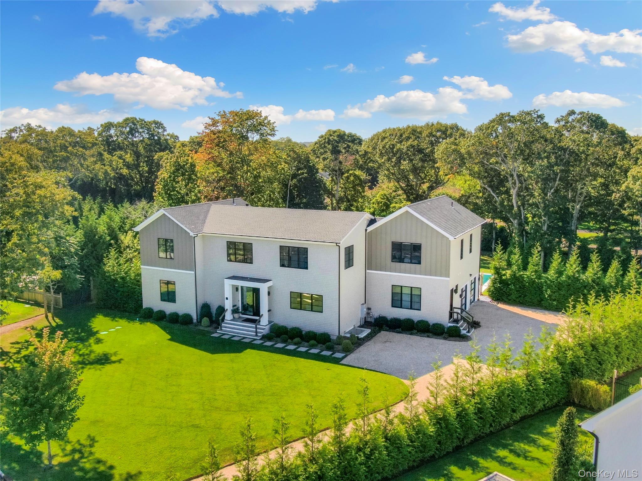 This modern masterpiece is nestled down a private lane with a cul-de-sac location in Quogue. This three-year-old residence exudes the epitome of the Hamptons lifestyle spanning 6,300 sq ft on three levels. Featuring 6 bedrooms and 6 1/2 bathrooms, all designed with en-suite facilities for your convenience and privacy. The open floor plan, which is the heart of the home, includes a gourmet kitchen, dining area and living area. There is also a den/office on the first level plus an en-suite primary bedroom that makes for easy living on the main floor. Designed with entertaining in mind these spaces invite you to host gatherings With ease. There is also a fully finished lower level with an additional living room, bedroom, with bath and gym. The beautiful, professionally landscaped grounds offer a serene retreat while the salt water heated Gunite pool provides relaxation or exercise. Ample driveway parking and a two car garage that has room for a lift finish off this one of a kind listing. Situated close to the charming Quogue village shops and Quogue's ocean beach.