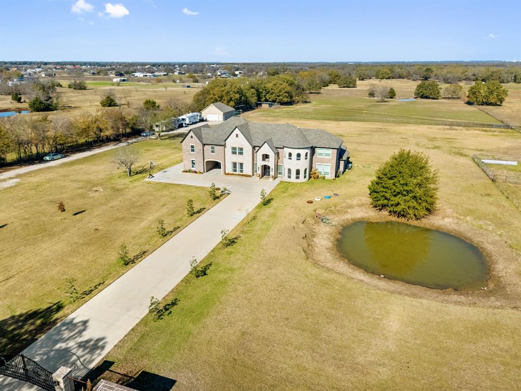 Exceptional Gated Multigenerational Home on 10.1 Acres in Royse City, Texas, total of 7,998sq ft of living space and offering privacy, and flexibility. The private gated entrance welcomes you into this expansive property designed for comfortable everyday living. The main residence spans an impressive 6,645 sq ft, featuring 6 bedrooms, 5 full bathrooms, and 2 half bathrooms, office, media room, dining room, 2 living rooms, 1 game room, open gym room and laundry room thoughtfully laid out to accommodate large or extended families. Interior highlights include quartz countertops, hand-scraped hardwood flooring throughout the home, custom built-in cabinetry in closet areas, 9ft ceilings in second floor, 10ft ceilings downstairs. In addition to the main home, the property includes two separate multigenerational residences, ideal for extended family, guests, or private living quarters.  Exterior features two Ponds, Metal shop, RV hookups and fully fenced in for all your horses and cattles. Set behind a private gate and surrounded by open acreage with AG Exempt and wide-open TEXAS skies, delivers peaceful country living with endless possibilities—yet remains just minutes from shopping, restaurants, and Lake Ray Hubbard, with quick access to major highways and located within the Royse City ISD. Come see for your self !
