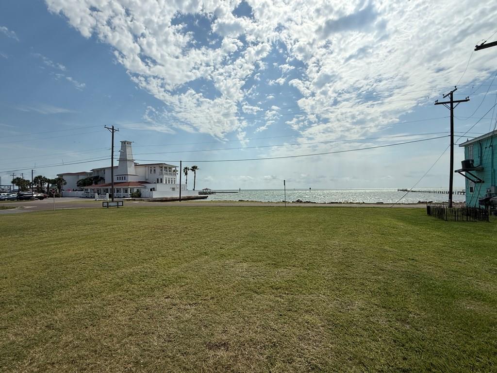 Rare Waterfront Opportunity in the Heart of the Texas Coast! Discover a one-of-a-kind property in beautiful Rockport, Texas—just minutes from the vibrant charm of downtown Fulton. This 0.55-acre lot offers an incredible 120 feet of direct waterfront access, making it the perfect canvas for your dream coastal retreat, new hotel or business, or other investment opportunity. Nestled in a prime location along the highly sought-after Fulton Beach Road area, this spacious lot delivers stunning panoramic views and refreshing sea breezes year-round. The expansive water frontage opens up a world of possibilities, from building a private dock for your boat to creating a tranquil outdoor space for fishing, kayaking, or simply soaking up the sun of Texas Gulf Coast. Surrounded by local attractions, this parcel provides the perfect blend of location and accessibility. Picture vibrant sunrises over the water, enjoying coffee overlooking the bay while watching coastal birds, or providing a location that someone can enjoy sunsets over Aransas Bay. The lot is cleared and ready for development, with ample space for a custom home, guest quarters, pool, or commercial building—whatever your vision may be. Public utilities are nearby, streamlining the building process. You're also just minutes away from top-tier dining, art galleries, fishing piers, and boutique shopping in both Rockport and Fulton, making this location a rare balance of tranquility and convenience. Whether you're an investor looking for prime coastal property or a homeowner in search of the perfect slice of paradise, this waterfront gem delivers unmatched potential and natural beauty. Opportunities like this don't come often—secure your piece of the Rockport coast today!