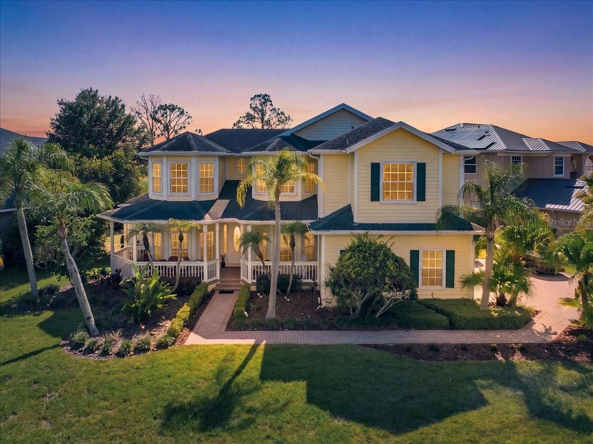 Experience ultimate waterfront luxury in the highly sought after, 24-hour guard-gated community of Cory Lake Isles. Perfectly positioned on an expansive, pie-shaped lot at the premier vantage point of a 165-acre ski lake, this Key West-inspired estate seamlessly blends resort-style living with everyday functionality.The main level welcomes you with timeless, rustic hardwood flooring leading into a light-filled open layout. A chef-inspired kitchen features custom beadboard cabinetry with pull-out storage, premium granite countertops, and stainless steel appliances—all framed by panoramic water views. The palatial primary suite serves as a private sanctuary, boasting a massive sitting area, a private sunset-view balcony, and a spa-like travertine marble bathroom complete with a dual-head walk-in shower with independent temperature controls.Designed for multi-generational living and entertaining, the floor plan includes four spacious bedrooms plus a massive upstairs bonus/theater room. Outside, your private oasis awaits: a custom 33’ x 17’ open-air pool with a dedicated sun-shelf, a heated Jacuzzi, and an expansive yard secured by an unobstructed aluminum fence. Enjoy premier lakefront access from your private boat dock, perfect for jet skis, boating, or fishing.Upgrades & Features:3-car garage with soaring 11 ft ceilings (ideal for extra storage)Wrap-around front porch & sweeping lakeside balconies2026 dock, seawallElite community amenities: Brand-new resort pool, clubhouse, tennis, basketball, and ball hockey courts.