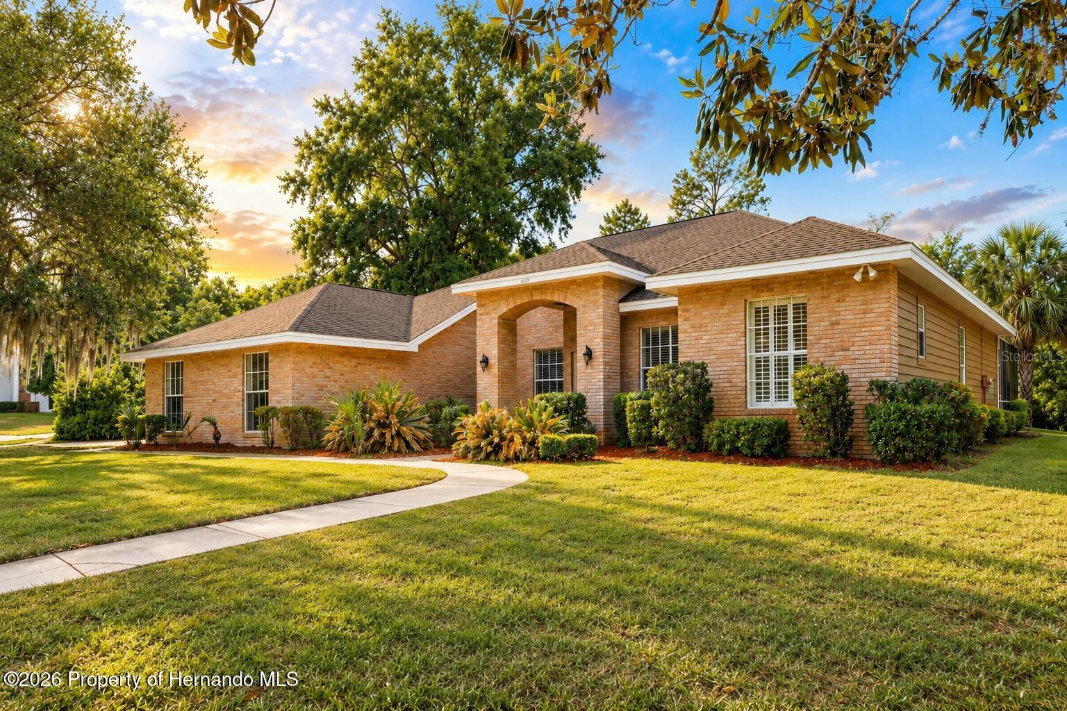 JUST REDUCED $45,000 || NOW $750,000 || GUARD GATED || PRIVATE WEEKI WACHEE RIVER ACCESS || HEATED SALTWATER POOL || 3-CAR GARAGE >>> What if you could live behind a GUARDED GATE, at the end of a CUL-DE-SAC, and be just a 3-MINUTE WALK from PRIVATE ACCESS to the WORLD-FAMOUS WEEKI WACHEE RIVER? This is a location you simply cannot recreate. Set on a .61-ACRE CORNER LOT near the back of this estate-style community, this 5-BEDROOM home offers 3,493 SF OF LIVING SPACE and 4,923 SF UNDER ROOF, plus access to a private community park where you can launch a kayak or paddleboard, swim, snorkel and enjoy one of Florida's most iconic spring-fed rivers. Tennis, basketball and pickleball courts add even more to the community lifestyle. >>> NOW LET'S TALK ABOUT THE HOUSE. Cedar siding, a brick front and GRAND DOUBLE LEADED-GLASS ENTRY create a striking first impression, while the 3-CAR SIDE-ENTRY GARAGE keeps the front elevation clean. Inside, GRAND COLUMNS frame the formal living and dining areas with HARDWOOD FLOORS and TRIPLE SLIDING GLASS DOORS overlooking the pool. Need a true HOME OFFICE? Double glass doors open to a private office with BUILT-INS and WAINSCOTING. Then you enter the FAMILY ROOM, and this is where the home really shows off. SOARING CEILINGS. FLOOR-TO-CEILING WINDOWS. WET BAR. ELECTRIC FIREPLACE! Natural light pours into a space that feels dramatic, open and completely different from the ordinary Florida floor plan! The RENOVATED KITCHEN features STUNNING GRANITE COUNTERTOPS, cooktop, wall oven and NEW APPLIANCES. The PRIMARY SUITE offers HIS-AND-HERS WALK-IN CLOSETS plus a spacious bath with SOAKING TUB and WALK-IN SHOWER. A SPLIT-BEDROOM PLAN includes two guest bedrooms with a shared bath plus a PRIVATE GUEST SUITE tucked toward the rear of the home. >>> AND THEN THERE'S THE BACKYARD. A TONGUE-AND-GROOVE CEDAR CEILING covers the outdoor living area overlooking freshly sealed BRICK PAVERS and a HEATED SALTWATER POOL AND SPA with IN-FLOOR CLEANING SYSTEM. The OUTDOOR KITCHEN features a NEW JENN-AIR GRILL, and there's even an OUTDOOR SHOWER with hot and cold water. NEW ROOF 2017 || NEWER HOT WATER HEATER || NEWER POOL PUMP AND FILTER || IRRIGATION WELL || NO FLOOD ZONE || NO CDD. At $750,000, you're not simply buying 3,493 square feet and a pool. You're buying the GUARDED GATE, the cul-de-sac setting, the oversized lot and PRIVATE ACCESS TO THE WEEKI WACHEE RIVER just minutes from your door. THAT is what makes 6153 New Osprey Point different.