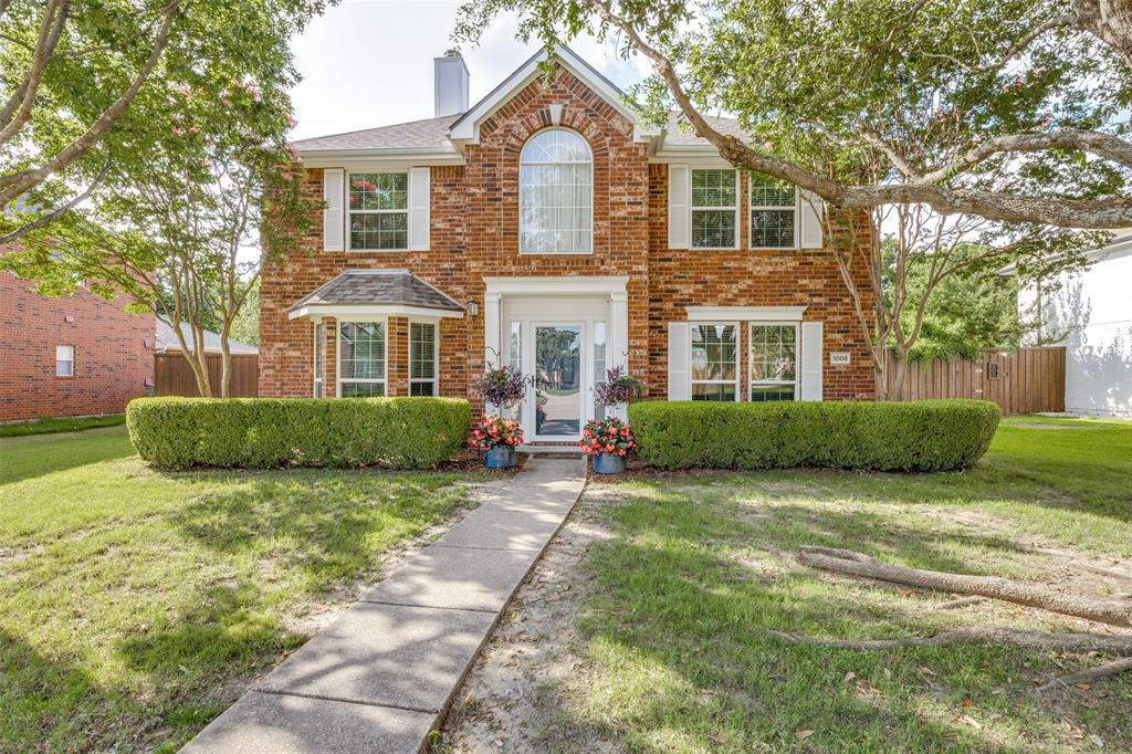 Beautiful 5-bedroom two-story home in Allen with mature trees, great curb appeal, and a backyard built for entertaining. Inside, luxury vinyl plank flooring runs throughout the home, complementing neutral paint, crown molding, arched openings, and updated lighting. The main level offers a formal dining room, a downstairs bedroom with closet that could also work well as a flex room or office, a comfortable living area with a fireplace and stone surround, and an updated kitchen that opens to the living space. The kitchen features white cabinetry, quartz countertops, a blue accent island, tile backsplash, black hardware, pendant lighting, stainless and black appliances, and a gas range. Upstairs, the spacious primary suite includes a sitting or desk area, great natural light, and a sliding barn door leading into the updated ensuite bath. The primary bathroom offers dual sinks, white cabinetry, black hardware, a dedicated vanity area, and a large walk-in shower with frameless glass, textured tile, pebble-style flooring, and modern black fixtures. Secondary bedrooms offer ceiling fans, good natural light, and flexible space for bedrooms, guests, or office needs. Out back, enjoy a private backyard retreat with a sparkling pool, raised spa with water feature, extended patio space, multiple seating areas, and landscaped areas framed by a wood privacy fence. Located in Allen ISD, minutes from Eagle Stadium, and close to Allen Premium Outlets, The Village at Allen, and Fairview Town Center for tons of shopping and dining options.