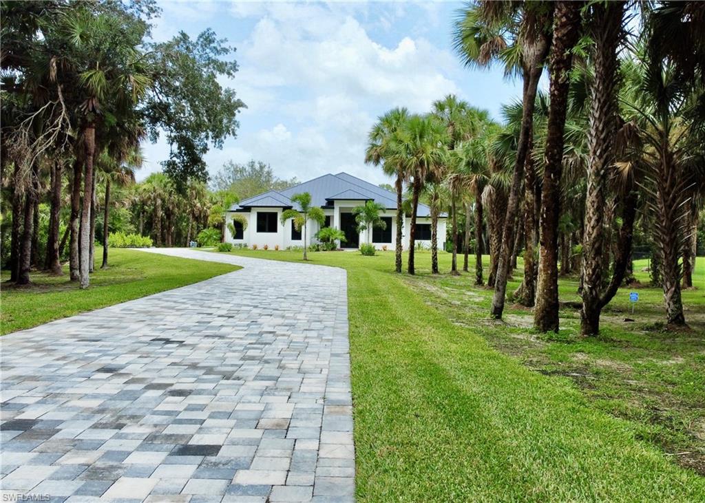 Just Completed - Luxurious New Construction Estate Residence. 
Welcome to a masterpiece of luxury living! This brand-new estate residence, completed to the highest standards, is situated on a sprawling 2.27-acre, 100% certified upland lot in one of Naples' most desirable locations. With 5,812 sq ft under roof, this home offers an exceptional blend of opulence, functionality, and serenity. Step inside to discover 5 bedrooms, 4 private en-suite full bathrooms, and 1 half bathroom, all thoughtfully designed with impeccable attention to detail. The Master and Junior Suites open directly to the pool, spa, and a stunning outdoor living area, featuring natural sandstone flooring, an outdoor kitchen and an oversized covered lanai—perfect for entertaining or relaxing in your private retreat. The fifth bedroom, thoughtfully positioned off the front entrance, doubles as an elegant home office. The living room features a modern gas fireplace, creating a warm and inviting ambiance, perfect for cozy evenings or hosting guests.
Soaring ceilings up to 15 feet create an airy and sophisticated ambiance, while the gourmet kitchen is a chef’s dream. It features high-end Thermador appliances, a 48" gas stove, double oven, separate cooling drawers, ice maker, wine cooler, oversized refrigerator and freezer, and an extra-large walk-in pantry/butler's kitchen. Situated in a FEMA X 500 elevated zone, flood insurance may not be required, adding peace of mind. Plus, with no HOA rules or fees, you’ll enjoy the freedom to truly make this property your own. Conveniently located just minutes from Publix, world-class shopping and dining, beaches, and all that North Naples has to offer, this estate combines privacy and accessibility like no other.
This is more than a home—it’s a lifestyle of luxury, serenity, and convenience. Don’t miss your opportunity to own this extraordinary property. Schedule your private showing today!