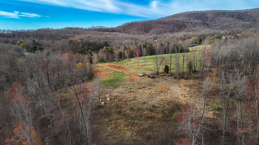 Discover the perfect blend of convenience, natural beauty, and readiness to build on this 15 acre tract located just outside the Town of Stuart- Patrick County, VA. Ideally situated at the end of Ashby Drive, this property offers privacy, long-range views of Stuart and the surrounding countryside, and approximately 500 feet of picturesque Mayo River frontage along its boundary.  All essential infrastructure is already in place, making this property ready for your dream home, mountain retreat, or future development. Features include: Town Water Installed – 1.5" water meter with 700 feet of 1.5" PEX pipe running to the building site. Town Septic Set Up – 4" PVC lines installed to the designated building area. Driveways with Culverts – Easy access and groundwork completed.  With its combination of usable land, modern utility connections, and scenic river frontage, this property offers a rare opportunity to build without the hassle of starting from scratch. Whether you're looking to create a private estate, a getaway spot, or invest in land with development potential, this tract is ready for your vision.  Don't miss the chance to make this beautiful piece of Patrick County yours!