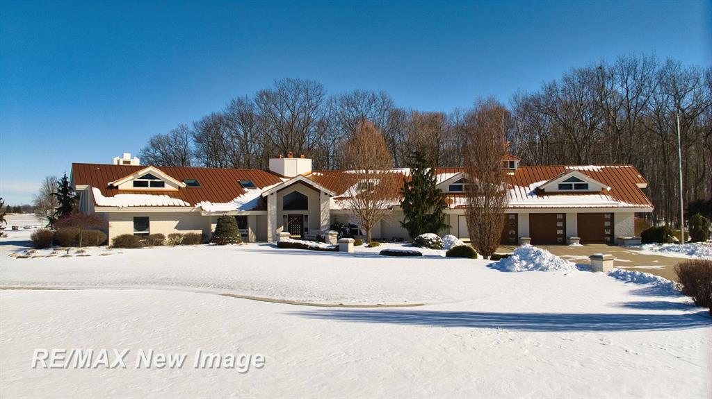 Welcome to one of the most impressive and immaculate luxury homes in all of Saginaw County. Nestled on 5 private acres in sought-after Thomas Township, this custom all-brick estate offers 5,108 square feet of exceptional design, craftsmanship, and elegance. A sprawling split ranch layout and immense architectural details are complemented by soaring vaulted ceilings and expansive windows that flood the home with natural light.  The stunning primary suite is a true retreat, featuring its own fireplace, a huge walk-in closet, jet tub, and a spacious walk-in shower. The home includes a sunken living room with fireplace, a family room complete with built-in bar, a bright sunroom with in-floor heating and its own additional bar, and a large office/den/workout room to suit your lifestyle. The main floor laundry adds convenience, while two bonus rooms upstairs provide flexible living space for guests, hobbies, or storage.  New boiler plus 2 gas forced air furnace and AC units.  Newer garage doors. The possibility for a 4th or even 5th bedroom is there.  At the heart of the home is a well-appointed kitchen with stainless steel appliances, perfect for entertaining or everyday living. Step outside to a massive wraparound patio with a built-in bar and grill-ideal for hosting unforgettable parties or relaxing family gatherings. Every detail of the property has been thoughtfully planned, including a heated, drive-thru 5-car attached garage with ceramic floors and a matching 60x40 all-brick detached 6 car garage featuring a small kitchen, half bath, and finished living or bonus space. Beautifully landscaped and meticulously maintained, this one-of-a-kind gem offers the perfect blend of luxury, privacy, and function. With a newer steel roof and skylights, 3.5 bathrooms (5 toilets), and unmatched attention to detail throughout, this is a rare opportunity to own a true estate in one of the area's most desirable locations.