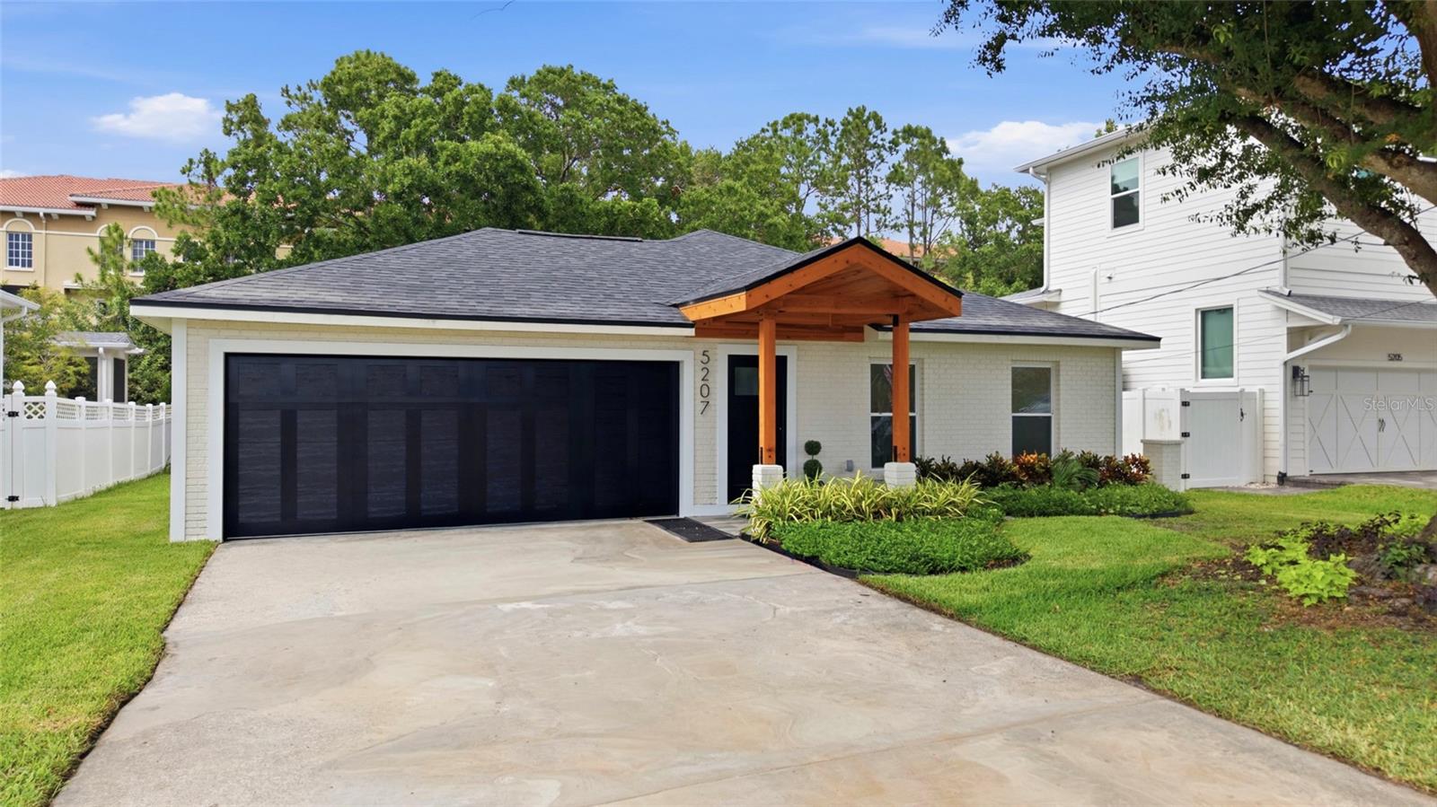 Fully permitted, architecturally reimagined, and comprehensively reconstructed in 2025, this Beach Park 4-bedroom, 2-bath residence lives like new construction while offering the character and convenience of one of South Tampa's most established neighborhoods. The home was taken back to its structural shell and rebuilt to current building codes, replacing and upgrading all major systems throughout. Inside, wide-plank flooring flows throughout the thoughtfully redesigned interior, featuring a designer kitchen with custom cabinetry, unique leathered granite countertops, new appliances, and a recessed ceiling-mounted ventilation hood that enhances openness and sightlines. Beautifully reimagined bathrooms showcase elevated finishes and timeless design, while a custom front gabled entry with clear-stained cedar accents creates exceptional curb appeal. The oversized two-car garage features a professionally finished polyaspartic floor coating.Major improvements include a new 20-year dimensional roof, new HVAC systems, complete electrical rewire with new service panel, hurricane-impact windows, Tesla charging station, 50-amp generator connection, newly constructed rear patio, refreshed landscaping, and all-new interior doors, hardware, trim, casework, fixtures, and architectural enhancements throughout. For full transparency, the home experienced a single minor water intrusion event during Hurricane Helene. As part of the property's comprehensive reconstruction, the seller proactively replaced the flooring and drywall, and the residence was subsequently rebuilt under permit with major systems upgraded to current building codes. The seller also offers a transferable flood insurance policy and has obtained a completed 4-point inspection for added buyer confidence. Situated on an 8,398-square-foot homesite and zoned for the highly sought-after Plant High School, this exceptional property is conveniently located near Westshore, International Plaza, Midtown, Downtown Tampa, and Tampa International Airport. A rare opportunity to own a fully permitted reconstruction featuring modern systems, no deferred maintenance, and the peace of mind associated with new construction in the heart of Beach Park.