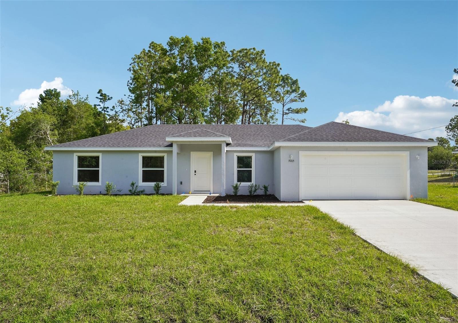 ** Buildering offering up to $9,000 in closing costs and offering special below marketing interest rates for qualifying buyers when using builders preferred lender*** Welcome to your Sanctuary Home—Brand-new construction offering modern design, upgraded finishes, and true move-in-ready convenience! This 4-bedroom, 2-bath home features durable block construction, a 2-car garage, and is located outside of a flood zone for added peace of mind. Inside, you’ll find luxury vinyl plank flooring throughout, quartz countertops, white cabinetry with black hardware, and sleek black fixtures. The open-concept layout is complemented by a full stainless steel appliance package, including refrigerator, washer, and dryer, plus blinds and ceiling fans already installed. Bathrooms showcase floor-to-ceiling tile and dual vanities, while soft-close cabinets and drawers add a high-end touch. With well and septic (no water or sewer bills) and a fully finished interior, this home delivers exceptional value compared to other new construction options—schedule your showing today!Situated in Silver Springs, this home offers convenient access to Ocala, along with nearby shopping, dining, and the area's renowned natural springs and outdoor recreation—while still enjoying a quiet residential setting.Move-in ready and beautifully appointed, this home delivers the perfect balance of style, comfort, and value—an exceptional opportunity for today’s buyer.