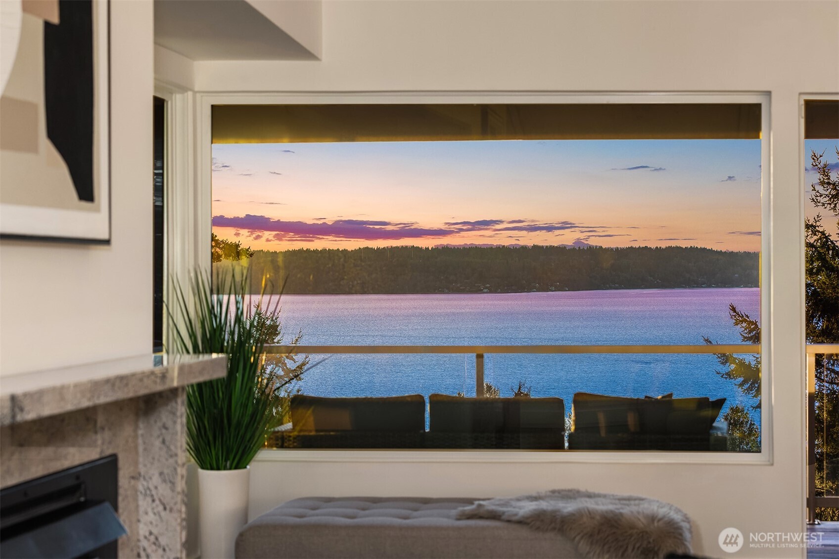 Seller is highly motivated and the price has just been improved, creating an incredible opportunity in Three Tree Point. Perched on the quiet western slope, this fully reimagined mid-century retreat captures sweeping Puget Sound and Cascade Mountain views from nearly every room. Surrounded by mature trees for exceptional privacy, the home blends modern design with effortless Northwest living.    The light-filled main level features vaulted ceilings, skylights, radiant heated tile floors, expansive windows, and an entertainer’s kitchen with Sub-Zero refrigerator, double wall ovens, walk-in pantry, large peninsula, and water views from the cooktop.    All three bedrooms are downstairs, including a spacious primary suite with deck access, stunning views, soaking tub, dual-head shower, and custom walk-in closet.    A versatile 600 sq ft lower level with private exterior access offers ADU, multi-generational, guest, office, or flex-space potential. Enjoy 1,500+ sq ft of wraparound decking on a generous 19,000 sq ft lot, plus a 2024 metal roof, detached 2-car garage, and plenty of parking. A rare opportunity for private, turnkey view living.