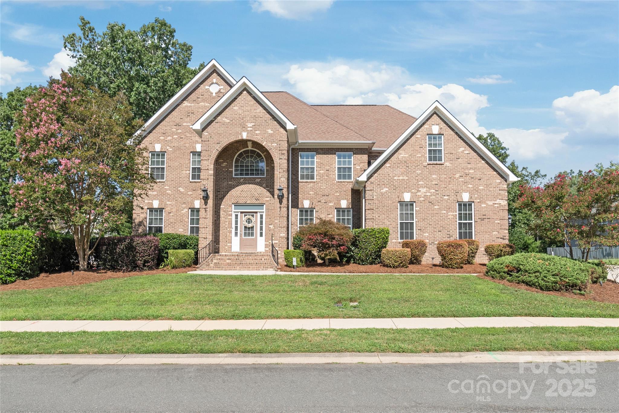 A rare gem in the heart of Locust, this one-of-a-kind full brick beauty sits on a lush half-acre in a sought-after, established neighborhood. Step into the grand foyer with gleaming hardwoods and wrought iron details, leading to a soaring living room with floor-to-ceiling windows, built-ins, and a cozy gas fireplace. Host with ease in the formal dining room, butler’s pantry, and warm, inviting kitchen with abundant cabinetry. Retreat to the luxurious primary suite with tray ceiling, dual walk-in closets, and a spa-like bath. Main-level and secondary bedrooms offer private or Jack-and-Jill baths for ultimate comfort. Outdoors, the expansive paver patio with wood-burning fireplace and built-in grill sets the stage for unforgettable gatherings. Move-in ready and rich in character—this is the home you’ve been waiting for!