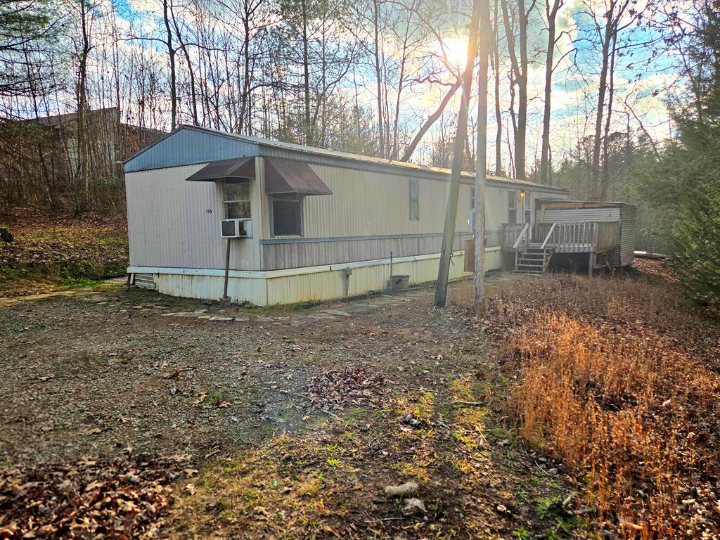 This 3-bedroom, 2-bath manufactured home being offered for sale that is located on rented lot.  The monthly rent to the landlord is $200.00 per month and includes the well water.   Inside, you'll find a spacious layout with a primary suite, two guest bedrooms, and plenty of potential. Outside?  Situated on a gentle, easy-to-maintain lot, you'll have just the right amount of space for a small garden without the upkeep of a large yard. Whether you're an investor, first-time buyer with vision, or someone who knows a good deal when they see it, this one's worth a look. Fix it up and cash in—or make it your own private paradise.  Full of possibilities. Come see the value—for yourself!  Seller is licensed realtor and managing member of accent awnings inc