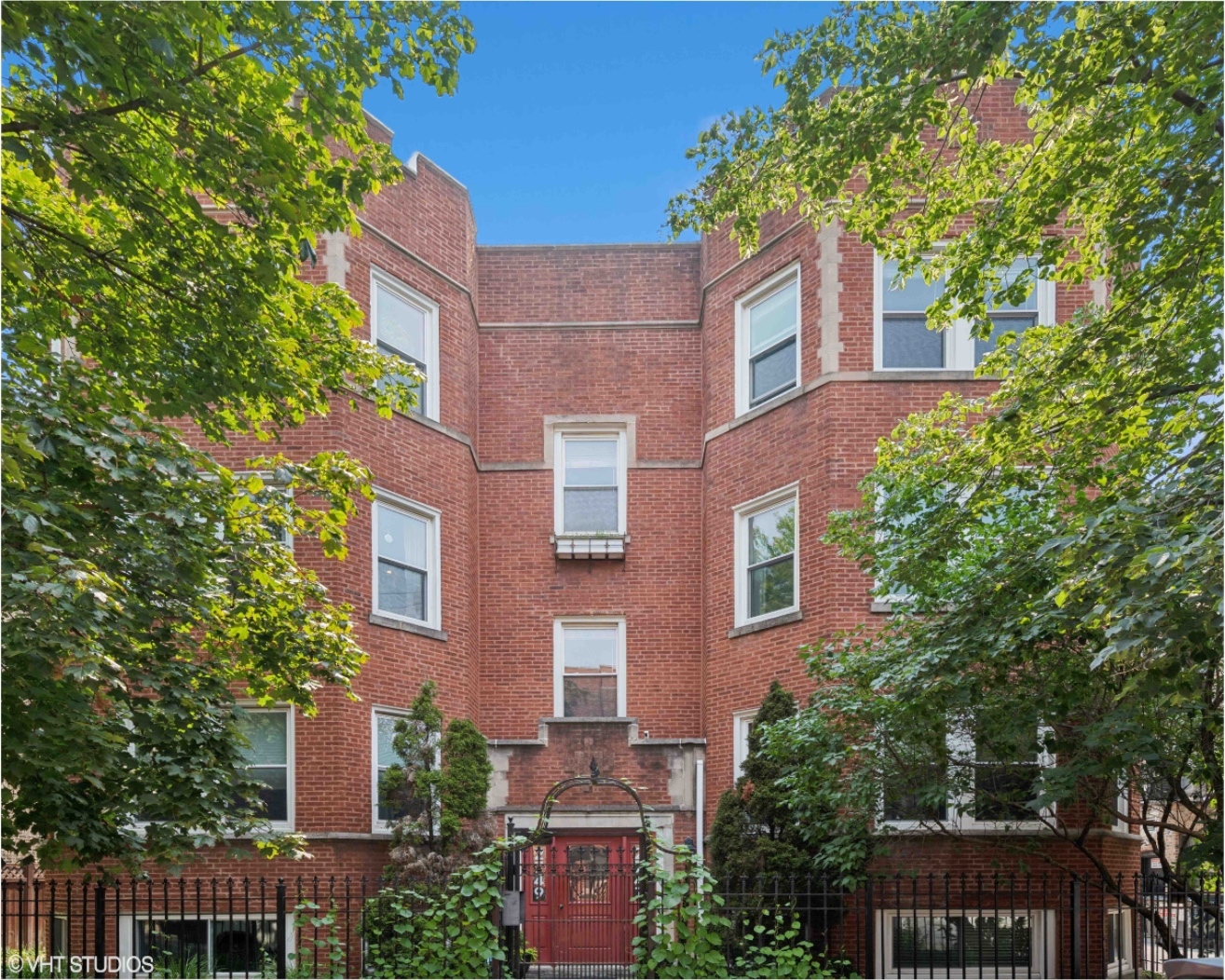 Welcome to this beautifully updated and sun-filled 2 bedroom, 2 bathroom condo located on a tree-lined street in Logan Square. Just steps from Milwaukee Ave, the Blue Line and the new La Placita Plaza, this spacious and thoughtfully designed home has modern updates throughout. The welcoming entry foyer leads into a bright living room, complete with rich hardwood floors, built-in bookcases, exposed brick and a wood burning fireplace. The open-concept kitchen and dining area features crisp white cabinetry, quartz countertops, an island with counter seating, stainless steel appliances and a disposal. A built-in desk in the dining area adds versatility for work-from-home needs. The primary suite has dual professionally organized closets and an updated bath with soaking tub and medicine cabinet. The second bedroom also has an organized closet and is located next to the second full bath, complete with a walk-in shower and designer penny tile. Enjoy the outdoors with your rear deck overlooking the shared yard space. Additional features include in-unit washer & dryer, recessed can lighting, ceiling fans, and a deeded garage parking space. Located in a an all owner-occupied, professionally managed and pet-friendly building, this condo offers both comfort and convenience in one of Chicago's most vibrant neighborhoods. Enjoy all the local shops, restaurants, cafes, parks and the Logan Square Farmers Market.