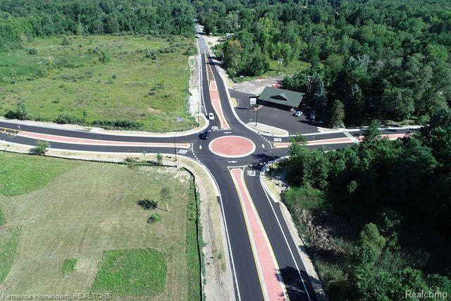 Sale includes both parcel ID numbers A00107100016 & A00107100013. Entire physical North West corner of 7 Mile and Pontiac Trail. Spectacular 15.9 acre piece located at the busy intersection. Round About is complete, New Garden center across the street. Part of this parcel is zoned residential, which may allow for some splits call Salem township for requirements, part of the parcel is local commercial see docs as to article 20 for what would be allowed.  Additionally in docs find flood certification info from FEMA maps. This property is open to a plethora of possibilities. Buy in now to develop or sit on and see what the future might hold, traffic counts going up annually.