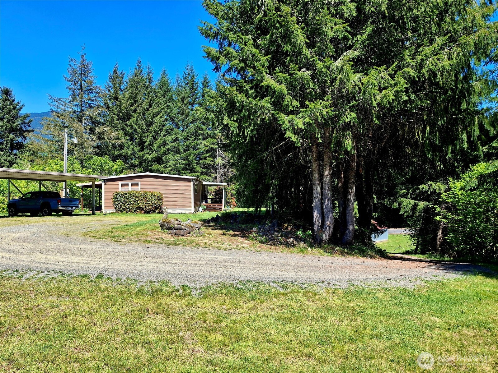 Well maintained 1971 Manufactured home on over 3 acres. Large carport, covered decks in front and back, long driveway keeps this cozy home secluded. Nice shop for tinkering, or a couple horses as it has been used for in the past. This one is cash only due to age. Do not fool you as it is well maintained. Just a short drive to the Gifford Pinchot for hiking, hunting and huckleberries! Skiing, fishing and more in the heart of the BIG BOTTOM VALLEY! We have a lender for this property! Please call for info.