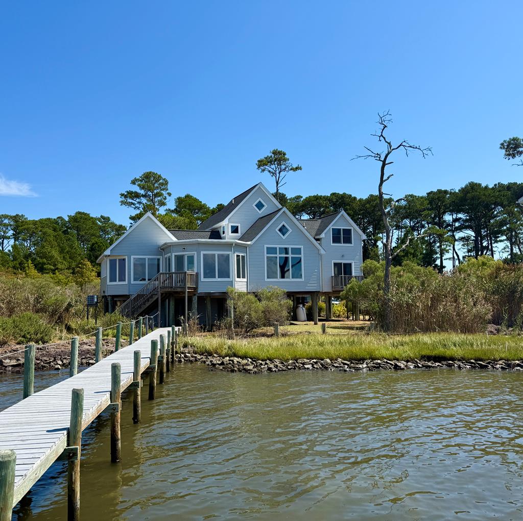 Premier Waterfront Island Home with NEW roof, front door, dual hvac system & staging! Private pier to launch your kayak, catch a fish, just sit back & relax! First level offers a spacious living room with Bay views, wood floor & fireplace, kitchen, dining room with door to back yard pier, den/family room with Bay views, full bath, Primary en-suite with Bay Front balcony & an additional bedroom. Second level offers two more additional bedrooms, bonus room with Bay view, full bath & great reading nook area. Front screen porch with a hot tub! Fully furnished. Dual Zoned with 3 NEW units & pedestals. Storage room. You will love the long picturesque driveway off of Wildcat! Spending days & nights on your private dock living the dream! Successful Rental. THIS HOME WAS FEATURED ON DELMARVA HOMES!