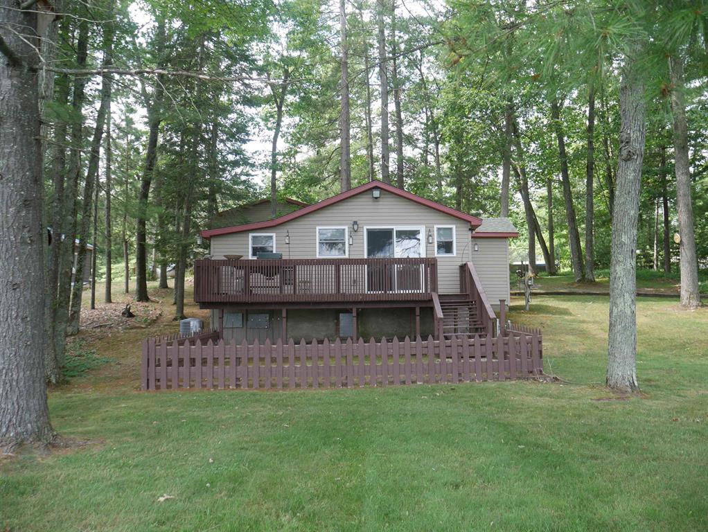 This well maintained home offers 100 feet of beautiful sandy frontage on the sparkling waters of all sports Jose Lake! Impeccably maintained inside and out, the home features many updates: new cabinetry and new appliances, fresh paint, newer furnace (2013), New roof (2015), 5 inch well, central air to keep you cool and comfortable and Generac generator so you never have to worry. Outside the 24x28 2 car garage is finished and heated with an exhaust fan for when you are working on projects, a screen to let the breeze in and keep the bugs out! There is even a two hole outhouse! Great for get togethers! The yard is graced with pear, peach, cherry and apple trees! There is a raised fenced in garden to grow your vegetables! accents, an inviting 10x24 deck perfect for relaxing or entertaining. Down by the cement firepit, there is room for seating and a place for 5 shade umbrellas so you can enjoy the outdoors! An extra 12x12 shed for your toys, this is the lakefront cabin everyone dreams of! A great place for swimming, fishing, or simply soaking in the view.