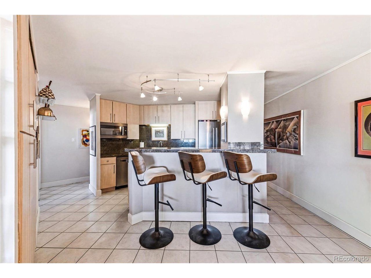 Experience elevated city living from the 7th floor in this beautifully updated 2-bedroom, 2-bathroom condo offering 1,373 square feet of stylish comfort in the heart of Capitol Hill with breathtaking city & mountain views! Thoughtfully renovated throughout, this well-light unit features natural hardwood floors, stylish painted/polished concrete flooring and a stunning open-concept kitchen that was renovated & designed for both everyday living and entertaining! The updated kitchen showcases solid slab granite countertops, custom cabinetry, and high-end Bosch stainless steel appliances for a sleek, cohesive finish. Escape to the primary suite with custom polished concrete flooring and 2 walk-in closets with built-in shelves and an updated bathroom that includes a double vanity with updated quartz countertops and oversized walk in shower. A secondary bedroom and bathroom offers privacy for visiting guests or space for a home office. Step outside to your private balcony and take in unobstructed views of the sweeping city skyline AND mountains - the perfect setting for morning coffee or unwinding at sunset! Residents of this secure high-rise enjoy exceptional amenities including a 24-hour concierge staff, outdoor pool, fully equipped fitness center, stylish clubhouse, rooftop garden with panoramic views of Denver's skyline and the Rockies, and a guest suite for visiting friends or family. Additional conveniences include a deeded & dedicated parking space and private storage unit. Ideally located in Capitol Hill that is close to public transit and offers unbeatable walkability to some of Denver's best restaurants, shops, parks, and cultural attractions. Whether you're searching for a sophisticated primary residence or a turnkey investment opportunity, this exceptional condo delivers the very best of urban Denver living!