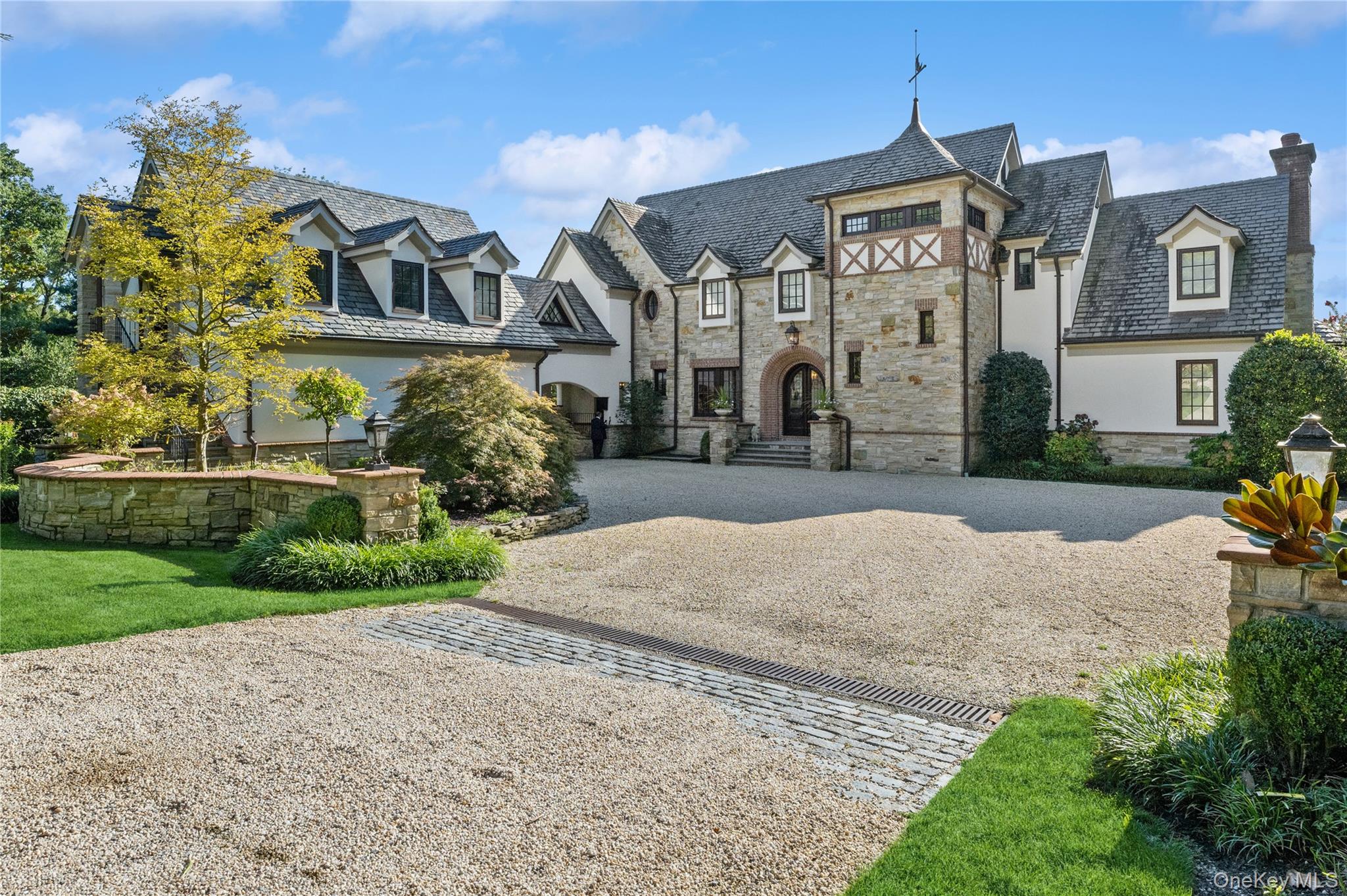 Overlooking picturesque Oyster Bay Harbor, this stately waterfront Manor home is located on 1.71 acres and boasts 245 feet of water frontage. Featuring 6 large bedrooms with walk-in closets and 7.5 baths with high-end fixtures and fittings, this magnificent property has an idyllic master retreat on the main floor with incredible views across the Harbor, 2 spacious walk-in closets with center islands, and a luxurious marble master bathroom with a soaking tub and an incredible shower for two. The foyer, with its grand mahogany entry doors and fielded wainscot paneling, leads to an open-plan bright and airy great room with a dramatic two-story ceiling, floor-to-ceiling stone fireplace, clerestory windows, and 3 sets of French doors that frame stunning water views. With herringbone floors, built-in cabinetry that offers ample storage, and glass doors for displaying china, the elegant dining room is perfect for gracious entertaining. The chef's kitchen has been designed with custom cabinetry, professional-grade appliances, 2 walk-in pantries, marble counters, an expansive marble center island with inlaid walnut butcher-block ends, and an octagonal breakfast area that overlooks the shore. A lovely conservatory/sunroom with terracotta flooring and a fireplace is located off the kitchen and offers an ideal spot for relaxing. The lower walk-out level features a paneled family room with a fireplace and coffered ceiling, a billiard room, temperature-controlled wine cellar, exercise room, custom onyx wet-bar, and an amazing home theater with a coffered ceiling, comfortable leather seating, and sound-proofed walls. The exterior has a generous bluestone patio, outdoor kitchen, and an incredible infinity pool in a beachfront setting with professional landscaping, manicured formal gardens, yoga platform, and a putting green. Additionally, there is a charming guest suite with a bedroom, bathroom, kitchenette, living and dining area. Complete with 6-zone central air conditioning and 15-zone heating systems, in-ground sprinklers, a 2-car garage, this exceptional "Smart Home" is the epitome of timeless design and showcases exquisite architectural details with extraordinary craftsmanship throughout., Additional information: Appearance:Diamond,Interior Features: Guest Quarters, Lr/Dr, Marble Bath