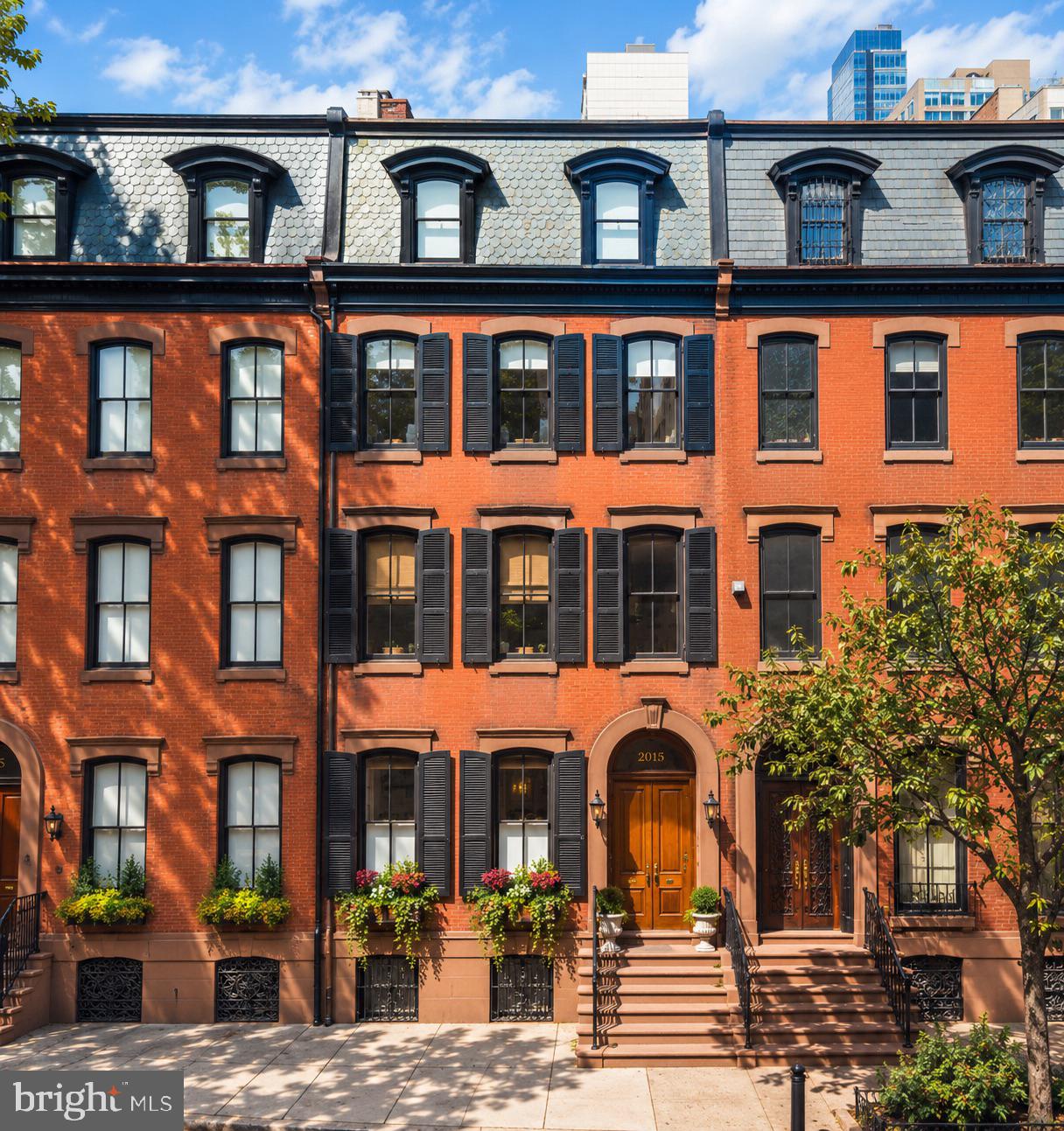 Located on one of Rittenhouse Square’s most distinguished residential blocks, 2015 Delancey Place presents a rare blend of historic character and modern refinement, offering 6,644 square feet of gracious city living with a two-car, side-by-side attached garage. Positioned within the Albert M. Greenfield School catchment, the home features soaring ceilings, oversized windows, six fireplaces, heated hardwood floors, and an elevator servicing every level, from the garage to the rooftop pilot house.The residence offers five bedroom suites, five full and four half baths, formal living and dining rooms, and a custom kitchen appointed with Miele, Wolf, and Sub-Zero appliances. Additional spaces include a library, media room with an expansive bar and kitchenette, home office, and flexible rooms suitable for a gym or additional living space. The primary suite occupies the second level with a fireplace, marble bath, generous dressing space, and a recently added den on the level above, transformed into an expansive walk-in closet and sitting area.Outdoor living includes a private terrace and expansive roof deck with skyline views, an outdoor kitchen and BBQ grill, cold plunge, sauna, hot tub, and dedicated areas for dining and entertaining.Just minutes from Rittenhouse Square Park and the Schuylkill River Trail, with convenient access to the Philadelphia Museum of Art, premier restaurants, hotels, spas, fitness clubs, and shopping. 2015 Delancey Place offers a private, exceptionally well-appointed residence that pairs refined interiors with the best of Rittenhouse Square just beyond its doors.