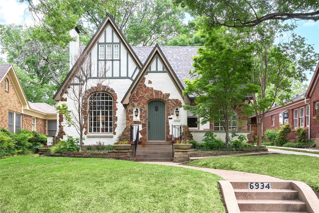 Charming stone-clad Tudor in the heart of Hollywood Heights, within the sought-after Lakewood Elementary school district. This distinctive 4-bedroom, 3-bath home blends historic character with thoughtful updates. Inside, you’ll find hardwood floors, coved ceilings, arched doorways, plaster walls, and a striking stained-glass window. A sunroom, custom cabinetry, built-ins, designer tile, decorative lighting, and a distinctive wrought-iron handrail add both beauty and function. The first-floor primary suite features an updated bath and an expansive walk-in closet with custom organization. Upstairs, three additional bedrooms share a full bath and a flexible living area—ideal for a playroom, office, or media room. Outdoors, enjoy landscaped grounds, a welcoming front porch, and a stone patio perfect for entertaining or unwinding. Just minutes from White Rock Lake, the Santa Fe Trail, Lakewood Country Club, and the shops and dining of Lakewood and East Dallas—this is a rare chance to own a classic Tudor in one of Dallas’s most desirable neighborhoods.