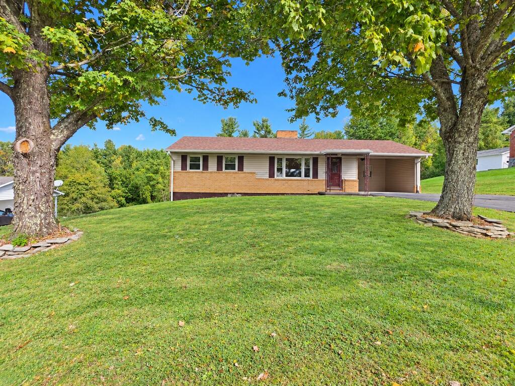 Charming 2-bedroom, 1.5-bath ranch-style home located on a quiet street in the desirable Fairview community! This home features hardwood flooring, a cozy living room with a fireplace, and a functional floor plan offering comfortable one-level living. Recent exterior improvements include a new roof, siding, and gutters installed in 2023. The full basement offers plenty of storage space and endless possibilities for additional living space to finish to your liking. Enjoy spending time outdoors on the large back deck, ideal for relaxing or entertaining family and friends. Additional features include a heat pump, county water, and a paved driveway. Conveniently located within minutes of the Blue Ridge Parkway, downtown Galax, the New River Trail, and many other recreational opportunities throughout the scenic Blue Ridge Mountains. Whether you're looking for a full-time residence, weekend getaway, or investment property, this home has plenty to offer!