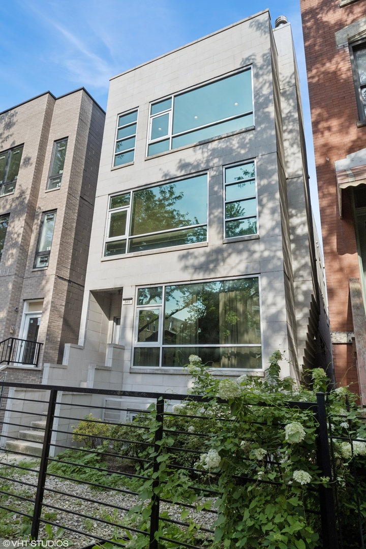 Stunning penthouse on a beautiful tree lined street located in the heart of East Village. Prepare to be wowed by this gorgeous 2-bedroom + den, 2-bathroom home with two private outdoor spaces where high design meets luxurious functionality. The open-concept living area is anchored by a custom fireplace and features oversized windows that fill the home with great natural light. Modern kitchen boasts custom Unico Italia cabinetry, SubZero, Miele & Bosch appliances, granite counters, and a large breakfast bar. The king size primary suite offers ample closet space including a walk-in closet and spa-inspired ensuite features a steam shower, custom tile, double vanity, high-end fixtures, and heated floors and towel bar. Wake up to skyline views from your oversized terrace, perfect for your morning coffee or a glass of wine. The generous second bedroom is accompanied by a stylish guest bath featuring custom tile and lighting, a floating vanity, and a Jacuzzi tub. The interior stairway leads to the second floor bonus room that can easily accommodate an office, complete with a wet bar, opening to your private fully built-out rooftop. The massive 1200 sq ft rooftop dazzles with breathtaking skyline views and is equipped with gas and water hookups plus outdoor speakers. Other notable features include white oak hardwood floor, built in speakers throughout, central air conditioning, and in-unit washer and dryer. Recent updates include water heater '25, Trex decking of the terrace, custom lighting, updated hardware, and fresh paint throughout. One assigned garage parking space equipped with EV charger and secure storage room are included in price. This newer construction home exudes sleek modern living at its finest with top of the line finishes. Pet friendly & investor friendly. Superb location just steps from Ukrainian Village, Wicker Park, West Town, and Division corridor, with easy access to restaurants, shopping, transit, and downtown. Welcome home!