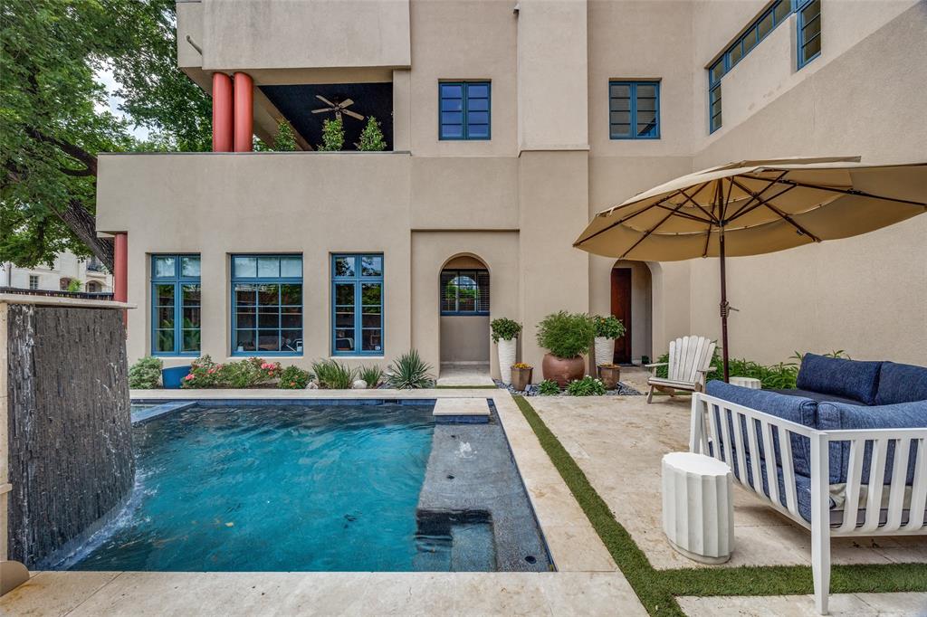 Price reduced! Spectacular single family home known as The Art House on Allen. Designed by noted Dallas architect Jack C. Irwin as his personal home, this property features a timeless California Modern Mission design that seamlessly blends indoor living with the outdoors. This urban private oasis is further enhanced by a recently added luxury pool, spa, and water feature. Situated in the desirable State Thomas neighborhood with downtown views, the home is within walking distance of local restaurants, grocery stores, retail shops, Griggs Park, and Klyde Warren Park, while offering convenient highway access. The residence is thoughtfully laid out across four floors, all of which are easily accessible via the home's four stop elevator. On the first floor, you will find a large third bedroom with a fireplace that could also serve as separate quarters, complete with its own kitchen and ensuite bath. The second floor features a spacious primary suite with a private lanai and a spa-style bathroom equipped with dual sinks, a spa tub, separate shower, and two walk-in closets. This level also includes a second bedroom that can function as an office with custom bookshelves. The third floor houses the main kitchen, living, and dining area, along with another lanai to enjoy the outdoor views. Finally, the fourth floor contains a finished room currently functioning as a home gym.