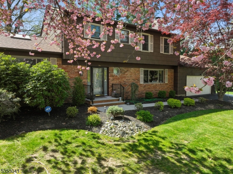 Welcome to your dream home in the highly sought-after Colonial Oaks neighborhood of East Brunswick! Tucked away on a quiet cul-de-sac, this beautifully maintained 4-bedroom, 2.5-bath Colonial is just minutes from top-rated schools, shopping, houses of worship, & NYC transp. Through the spacious foyer step up to the bright and airy living rm, where a vaulted ceiling, large windows, & 2 immense skylights fill the space with natural light. HDW flrs flow from the living rm into the formal DR, creating a warm setting for gatherings. The heart of the home is the chef's EIK, featuring granite counters, tile backsplash, SS appls, under-cab lighting & a pantry. A sun-drenched bfast area w/ surrounding windows & skylight provides the perfect morning retreat. Sliding doors open to a large deck that overlooks a fenced, prof landscaped backyard complete w/ mature trees, new plantings, paver walkway, & irrigation system. A welcoming family rm w/ WB fpl, a laundry/mudrm, powder rm, & access to attached 2-car garage complete the 1st floor. Upstairs, find 4 generously sized bedrms, incl a serene primary suite w/ bath, as well as an updated hall bath. The finished basement offers incredible space with a lg media room, a rec room & a bonus rm currently used as a home office. Important updates include newer HVAC, water heater & roof. A security system adds extra comfort & protection. Don't miss your chance to own this exceptional property in one of East Brunswick's most desirable neighborhoods!