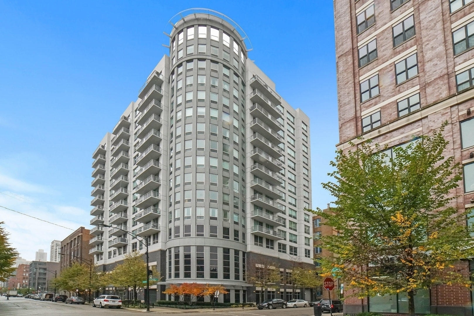 ONE OF THE MOST UPGRADED HOMES IN RIVER NORTH!  This stunning northeast corner penthouse offers sweeping SKYLINE VIEWS and an impeccable, top-to-bottom renovation. Every surface has been meticulously remodeled, featuring wide-plank hardwood flooring, custom millwork, designer lighting, and custom window treatments throughout. Custom kitchen is a showstopper with classic white shaker cabinets, dramatic Calcutta countertops, a waterfall island, high-end stainless steel appliances, and designer glass backsplash. Both bathrooms have been fully remodeled with custom cabinetry, premium tile, and luxurious finishes. The primary bathroom features a double vanity, waterfall shower head, and custom glass enclosure. The king-sized primary suite also boasts panoramic views and a professionally organized walk-in closet with Elfa systems. The spacious second bedroom easily accommodates a queen bed and a dedicated home office setup. 3 GARAGE SPACES AVAILABLE: PRIME west single space for $35,000; tandem space for $50,000. All of this in the heart of River North-steps from dining, nightlife, parks, and public transit. Huron Pointe is a full-service luxury mid-rise offering 24-hour door staff, a fitness center, and a rooftop deck with stunning city views.