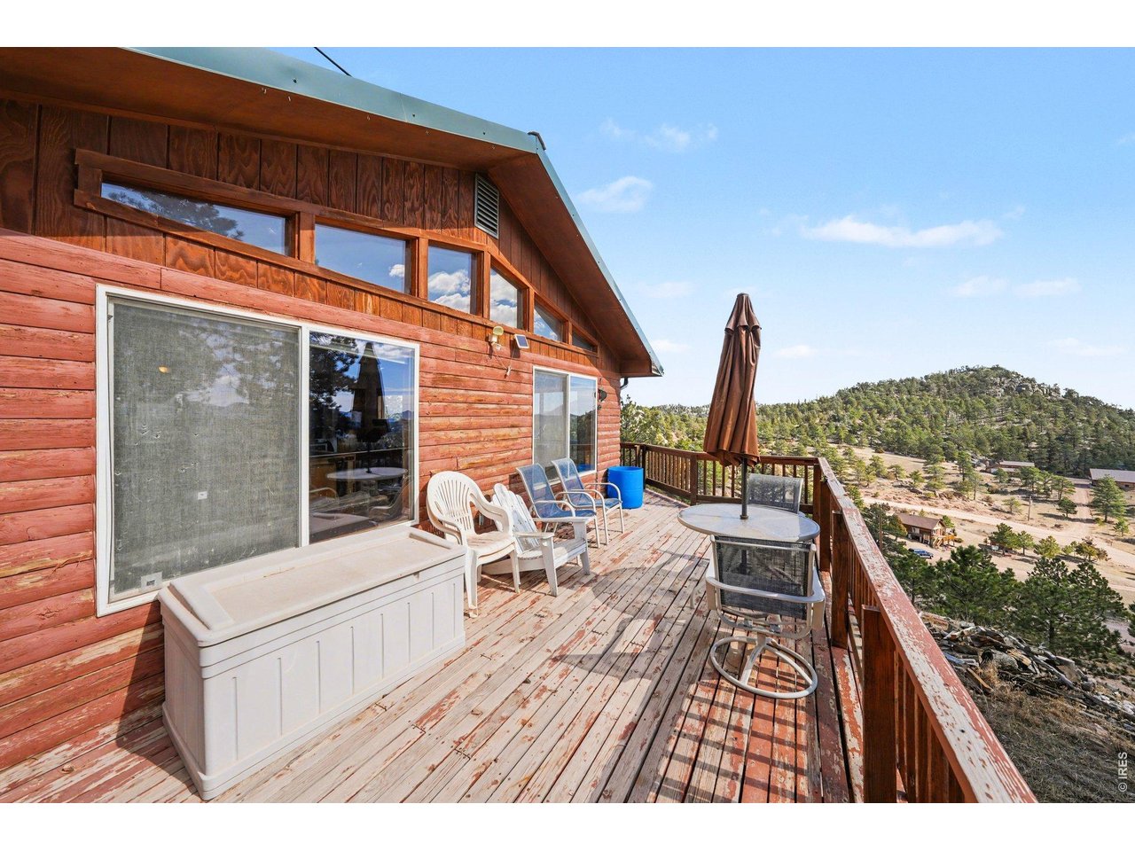 Recently renovated. HOA is Road Association only. This residence offers the best of mountain life, defined by peaceful surroundings and sweeping, unobstructed views of the Mummy Range. The property itself is a natural playground, featuring impressive, climbable rock formations right in your own backyard. The versatile two-story layout is ideal for multi-generational living or a guest-ready retreat; the lower level includes a functional kitchenette, two bedrooms, a 3/4 bath, and a laundry area. You will also find a spacious workshop on this level with a dedicated door to the yard-perfect for projects, gear storage, or a home studio. The upper floor serves as the main gathering space, featuring soaring vaulted ceilings and an open-concept kitchen and living area. A cozy wood-burning stove anchors the room, while a large door leads out to the expansive deck-the ultimate spot to take in those tranquil mountain vistas. Two additional bedrooms and a full bathroom complete the upper level. Thoughtfully equipped for the high-altitude climate, the home includes a dedicated heater for the waterline running from the well to the house; for easy winter maintenance, the heater plug is located in the southeast bedroom on the lower level. Enjoy the true sounds of the wilderness with the nearby wolf sanctuary's evening howls. Whether you're looking for a peaceful full-time residence or a weekend getaway where you can add your own personal updates over time, this Red Feather Lakes home is a rare find.