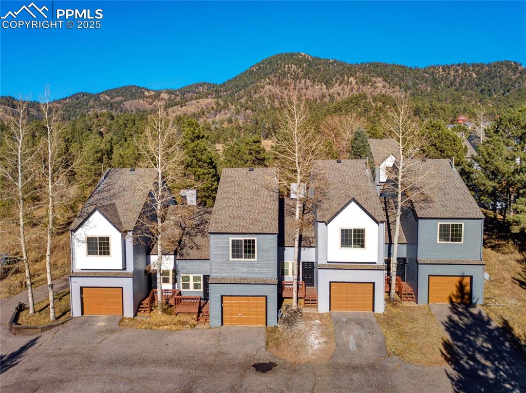 Welcome to the Green Mountain Falls Townhome Association, a unique community featuring eight beautifully renovated
townhouses. This exceptional project has recently undergone significant upgrades, making it a fantastic move-in-ready
option. Exterior improvements include new asphalt, xeriscaping, fresh exterior paint, new decks, and upgraded garage
openers, along with a five-year roof certification. Inside, you’ll find new light fixtures, hardware, paint, flooring, and
updated hearths and fireplace tile, among many other enhancements. Step into the inviting living space, where vaulted
ceilings and a wood-burning fireplace create a warm atmosphere. The updated kitchen, featuring granite surfaces and
stainless steel appliances, combines style and functionality. The open layout effortlessly connects the family room, kitchen,
and dining area—perfect for entertaining or relaxing after a day of outdoor adventures. Enjoy the new wood deck, where you
can soak in the serene natural surroundings. Upstairs, the spacious primary bedroom provides a tranquil escape, complete
with a walk-in closet. The versatile loft can be used as a home office, workout space, or cozy reading nook. An attached onecar garage adds convenience. This inviting community offers easy walkability to the charming amenities of Green Mountain
Falls and is conveniently located between Manitou Springs and Woodland Park. With the townhomes now in top condition,
this is a wonderful opportunity for buyers looking for a vibrant and well-maintained mountain community!