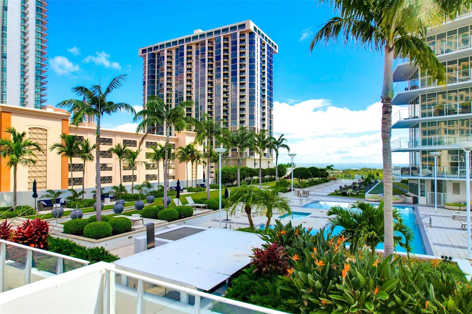 Virtually Staged. You won’t want to miss this beautiful one owner condo in the highly sought-after luxurious Signature Place Condos. This condo is one of only three in the complex with a 700+ square-foot private patio overlooking the resort style amenities deck with a picturesque view of Tampa Bay in the background. This unit is located in the smaller section of the building known as the West Lofts with remote keycard access doors and private elevators servicing just 22 units. Once you step inside the unit, you will be immediately greeted with an open floor plan illuminated with natural light from the floor to ceiling windows that offer a truly spectacular view. Looking for a more intimate moment? The windows are equipped with remote control blinds for privacy at the touch of a button. The kitchen is a host’s dream with sleek modern cabinets, stainless steel appliances and quartz countertops, all of which open to the living and dining spaces, with easy access to the large half bath and the beautiful patio ideal for enjoying a meal with company or just relaxing after a busy day. The beautiful primary suite also has floor to ceiling windows for when you want natural light, but remote blinds for added privacy, two closets with built ins and a large ensuite bathroom with dual sinks, a large soaker tub and stand-alone shower. The den has been converted into a dreamy custom dressing room with built in closet system. The unit also has a climate controlled storage space and assigned parking spot in the gated access garage. Signature Place Condo’s aren’t just a beautiful place to live, but truly a lifestyle. Amenities include 24 hour concierge for convenience and security, a large resort style amenities deck with pool and spa, lounge chairs, grilling and dining space, putting green, green space for exercise or meditating (Did someone say sunset yoga every Wednesday evening?) , fully equipped fitness center, multiple party rooms with pool table, lounge, media/library room, and gathering space. Signature Place is perfectly located for downtown living and is directly across the street from where the St. Petersburg Saturday Morning Market is and is walking distance to Rowdies Stadium, Mahaffey Theater, Pier One and Demens Landing Park, Beach Drive which is home to numerous award winning shops and restaurants including the Sundial Shops, the Dali Museum, the St. Petersburg Museum of Fine Arts, Pioneer Park, St. Petersburg Pier, Jannus Live and so much more! Come see this place before it’s too late!