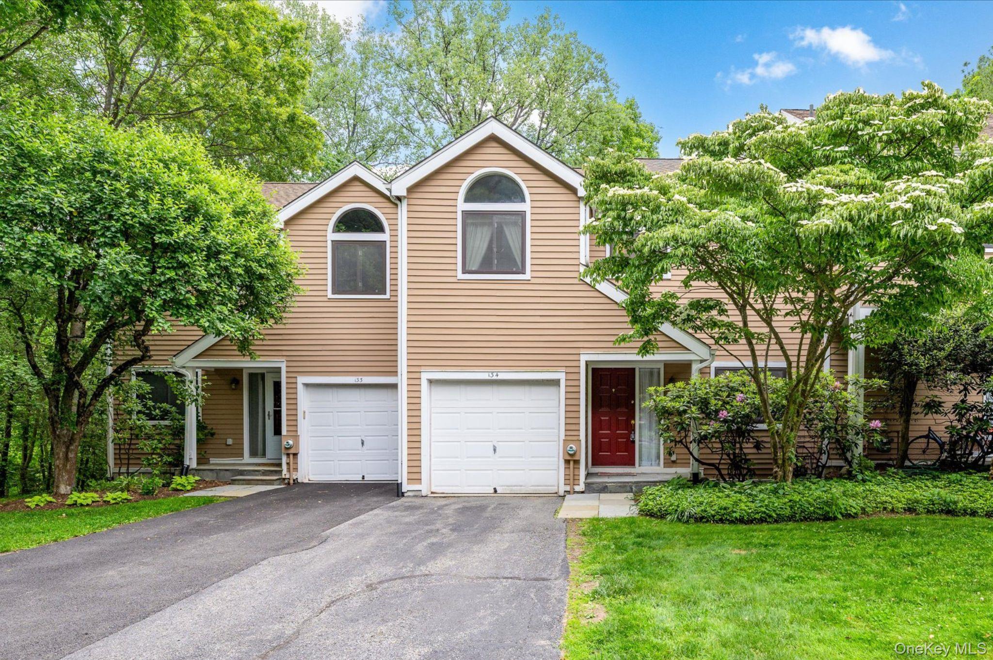 Welcome to 134 Bayberry Close in the sought-after Old Farm Lake community, in the heart of Chappaqua. This spacious 2-bedroom, 2.5-bathroom townhouse offers over 1,800 sq ft of living space across three levels, including a finished walk-out lower level. The main level features an eat-in kitchen, a dining area with sliding glass doors to the deck, and a sun-filled living room with cathedral ceilings and a fireplace. Upstairs, the nicely sized primary suite offers a walk-in closet and en-suite bath, while the second bedroom features its own full bath. Laundry is conveniently located on the upper level. The lower level provides valuable flexible living space, featuring a family room and a separate area ideal for a home office, gym, or guest space.  Residents enjoy exceptional community amenities including pool, tennis courts, clubhouse, playground, and basketball court, all just minutes to town, train, shopping, and top-rated Chappaqua schools. A rare opportunity to own in one of Chappaqua’s most desirable condominium communities. Additional highlights include a new water heater, central air, natural gas heat, attached 1-car garage, and excellent storage.