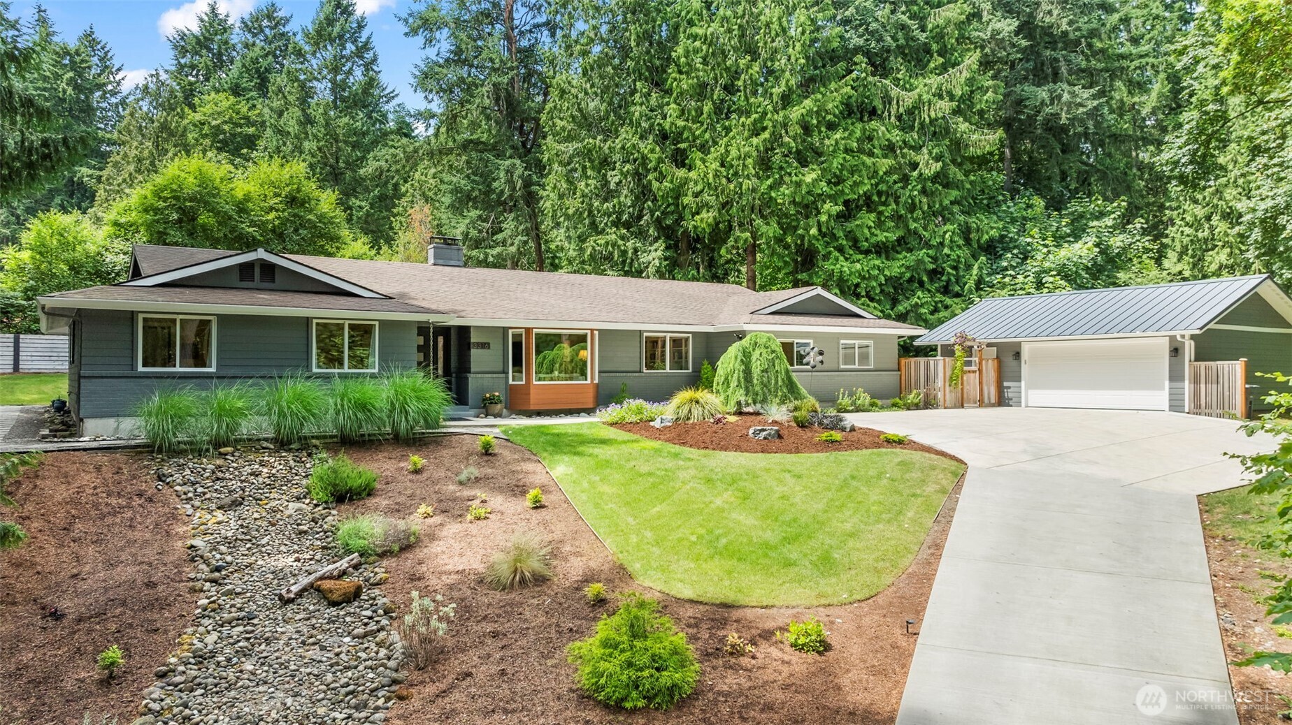 A home with soul, set on a sunny, elevated lot in the heart of Gig Harbor. This timeless rambler has been thoughtfully transformed to blend modern ease with a creative spirit.  The heart of the home is vibrant and warm, from the beautifully renovated kitchen to the rich, window wrapped, library lined, living room.  Two primary suites are the anchors - (one especially generous) each with privacy and comfort inviting the outside in.  A third expansive bedroom flexes as an office, art space, or guest retreat.  Outside, tranquil spaces beckon with lush gardens, private patios, and wooded serenity.  A new 725 sf garage completes the package.  Each corner carries intention - inviting you, like a novelist, to write your own story here.
