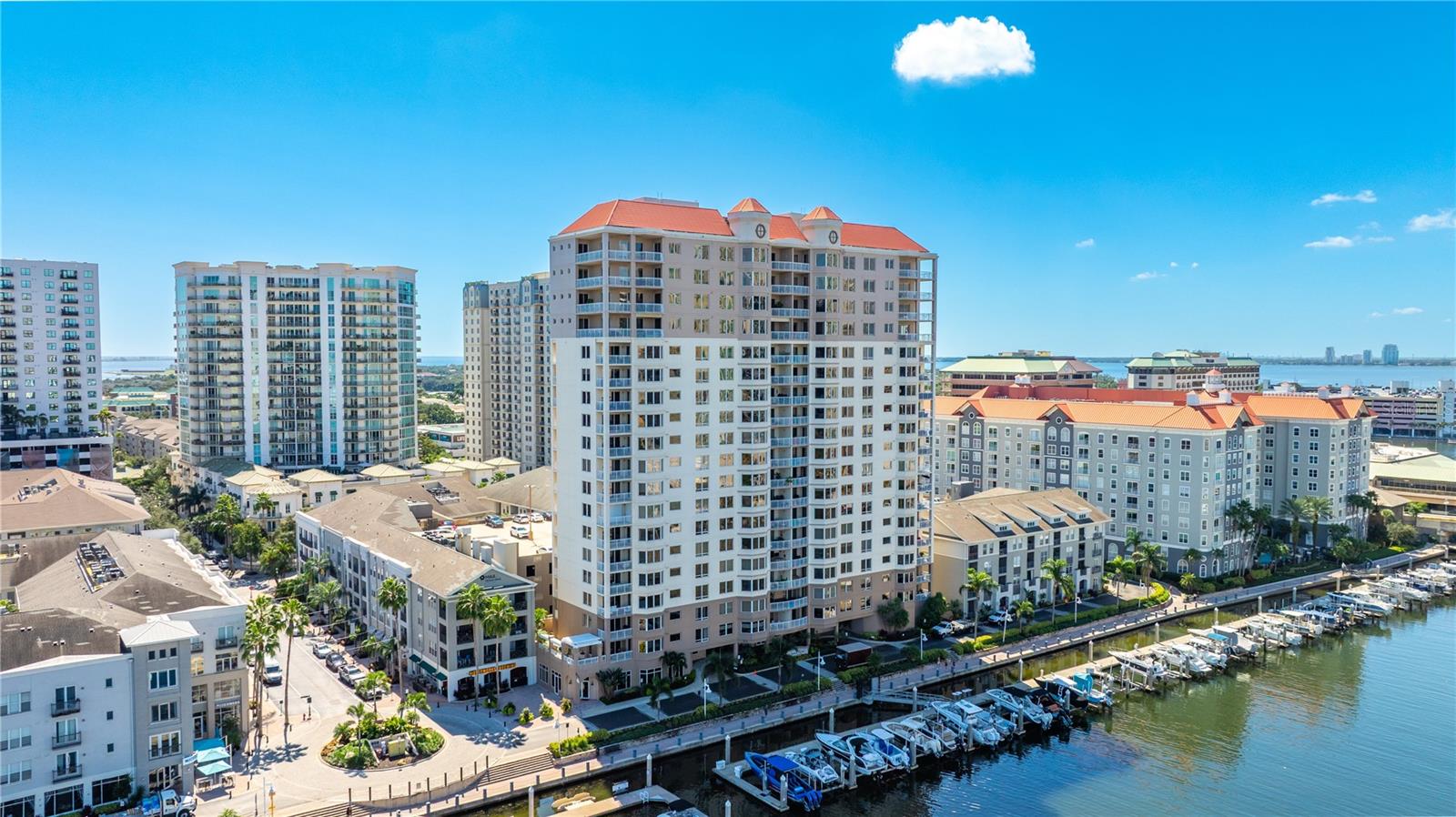 Experience pinnacle living high above Tampa’s most coveted private Island. Perched on the 11th floor of The Grandview on Harbour Island, this exquisite executive residence captures breathtaking panoramic views of the downtown skyline, Benchmark International Arena, and the shimmering waters of Garrison Channel.
From the moment you enter, natural light fills the open-concept great room, accentuating gleaming engineered hardwood floors and expansive floor-to-ceiling windows that frame the city’s most captivating sunsets. Motorized shades offer effortless comfort and privacy, while the modern kitchen features sleek granite countertops, a breakfast bar, and abundant counter space—perfect for both entertaining and everyday dining.
The spacious primary suite provides a tranquil retreat, large enough for a desk or intimate seating area, and opens directly onto a private balcony where you can unwind with stunning waterfront and skyline vistas. The spa-inspired ensuite features dual vanities, a generous walk-in shower, a separate soaking tub, and a spacious walk-in closet, all designed for relaxation and elegance. 
With only one other residence sharing the elevator lobby, enjoy an elevated sense of privacy and exclusivity. Two premium parking spaces complete this exceptional offering.
Nestled on glamourous Harbour Island, one of Tampa Bay’s most sought-after private island communities, The Grandview offers the ideal balance of serenity and sophistication where residents enjoy access to four resort-style pools, a fully equipped fitness center, and the convenience of being steps away from Benchmark International Arena, Water Street, Sparkman Wharf, and the best of South Tampa’s dining, shopping, and entertainment. Discover the ultimate in luxury, lifestyle, and location—a rare opportunity to live, work, and play on one of Tampa’s most prestigious locations