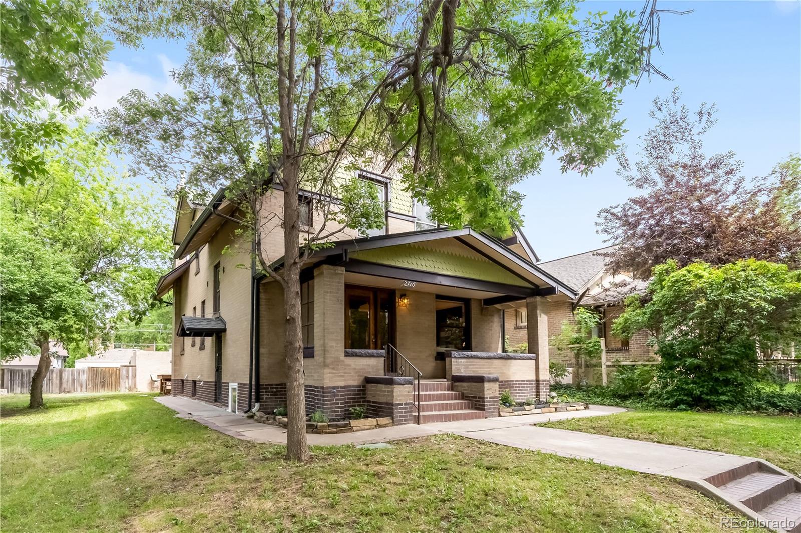 This beautiful brick home sits proudly on a rare and incredible double lot. Originally built as the neighborhood architect’s personal residence, it was crafted with the finest materials and tradespeople of the era and meticulously maintained. None of the old-growth woodwork has ever been painted. Antique wrought-iron fencing frames a generous Denver front porch, perfect for coffee, conversation, and neighborhood connection.Step through the original glass front door into a grand foyer with floor-to-ceiling oak columns and whisper-quiet Douglas Fir floors. The living room features stained-glass windows, a tiger-oak fireplace mantel, and handcrafted details. Sliding pocket doors open to the dining room with a quarter-sawn oak and leaded-glass buffet, while south-facing bay windows flood the space with Colorado sunshine. A powder room and hallway hutch add charm and function.The renovated kitchen blends historic craftsmanship with modern convenience, offering custom solid oak cabinetry designed to match original built-ins, stained-glass lighted cupboards, under-cabinet lighting, walk-in pantry, granite countertops, and stainless GE appliances. A private office with luxury bath and separate entrance provides lock-off flexibility.Upstairs are three spacious bedrooms with large walk-in closets. The primary bedroom includes dedicated AC, laundry closet, private balcony, and plumbing for a future en-suite bath. Don’t miss the attic bonus room. The fully finished basement features two bedrooms, kitchen, living area, shower, additional laundry, and is continuously rented for $2,400/month—ideal for multigenerational living or rental income.Outside, the expansive yard of this rare double lot offers exceptional potential for a future build or dream garden. Enjoy flagstone patios, a deck, custom pergola, and a two-car garage with ADU potential.
