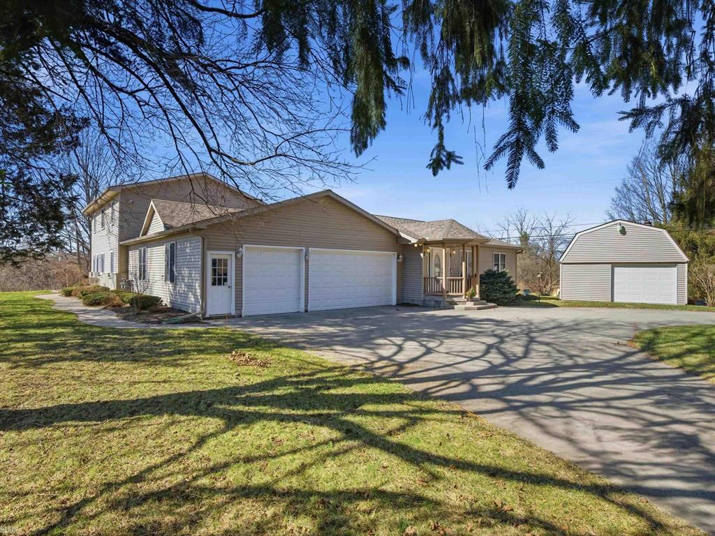 Unique home offering historic character and generous living space, originally built in 1870 with a thoughtfully designed addition completed in 2003. This spacious property features a total of 6 bedrooms and 4 full bathrooms, providing plenty of room for a large household, guests, or flexible living arrangements. The addition includes two bedrooms, a full bathroom, a second kitchen, and a living room that is seamlessly connected to the original structure to create one cohesive home. Inside, you'll find large living areas, abundant natural light, and a versatile layout that allows for multiple living and entertaining spaces. Situated on just under an acre, the property offers a spacious yard with room for outdoor activities, gardening, or future improvements. A pole barn provides additional storage or potential workshop space. Conveniently located on 34 Mile Road, the home offers easy access to nearby communities while maintaining a peaceful rural setting.