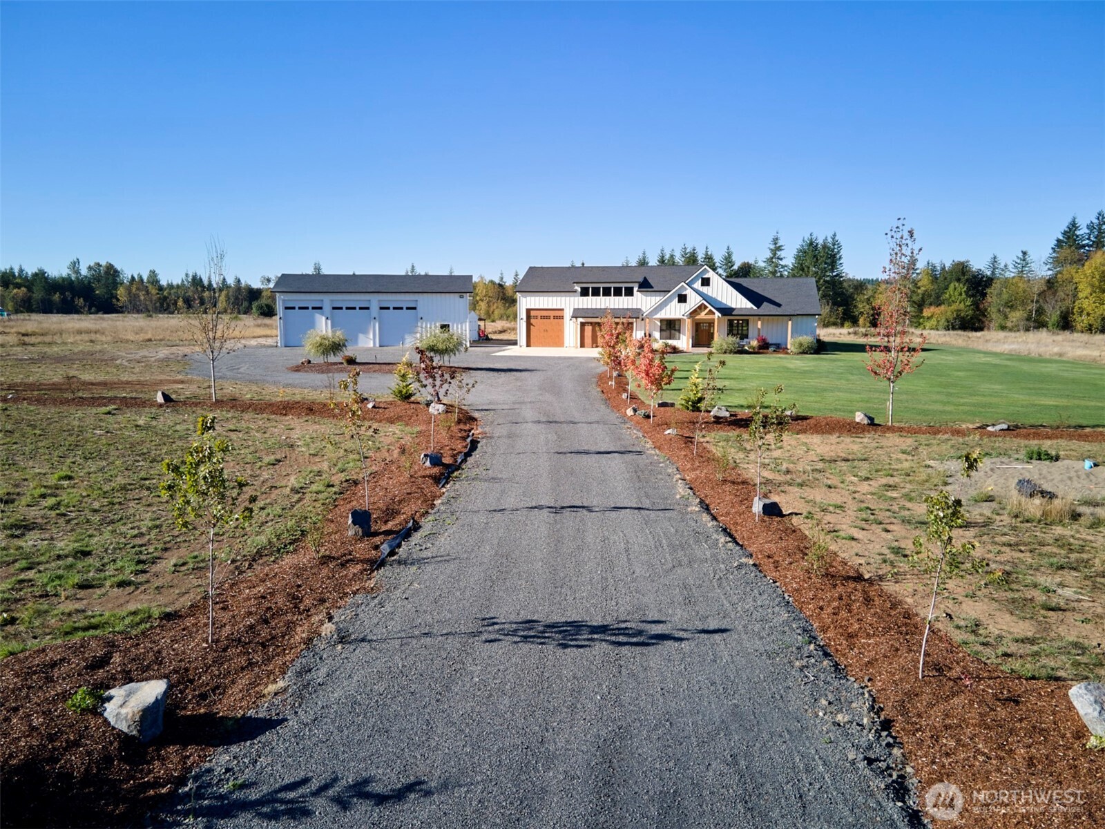 Coming home has never looked so fine! Showcasing an estate aesthetic with an inviting vibe this property rings true that the good life starts here, with an on-trend one level Modern Farmhouse w/attached RV garage & separate 44' x 56' shop, located along a private tree lined driveway on 20 flat acres. The covered front porch welcomes into the vaulted living rm w/fireplace & built-ins that opens to the timber frame covered patio. The kitchen serves as grand central in beautiful fashion w/an 8' island, white quartz cntrs, soft close cabs, SS appls & built-in cup cleaner at the sink. Adjacent to kitchen is a huge WI pantry w/counter & shelving. The Primary Suite is a private oasis situated on the west wing away from the heart of the home, featuring a glorious bathroom w/herringbone tile, soaker tub, oversized tile shower & WI closet. With excellent high speed internet, 2 den/offices,& Cat 6 cabling, it's easy to work from home. The attached 2 car + 16'x 35' x 16' high RV/Boat garage is a scene stealer! Bonus rm over garage offers extra rec-space. 44 x 56' shop w/14' open bays (12' x 14' doors) has a finished concrete floor & 200 amp service. Sauna on covered patio for easy year-round enjoyment. Property in Desg. Forestland (re-planted in 2026), providing the benefit of lower property taxes! Individual high producing well. Toledo schools. If dirt-biking is your thing- there are trails ready to go! Loads of parking & room to spread out and enjoy this epic estate. So much to offer!