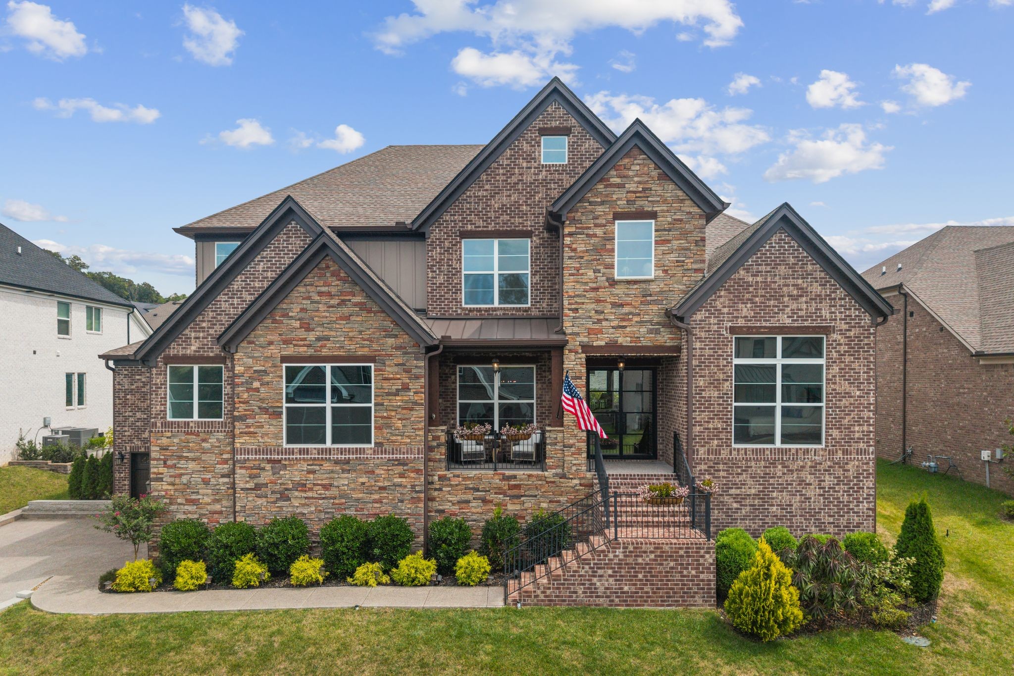 Welcome to 616 Silva Ln, where luxury, space, and Tennessee beauty come together in desirable Williamson County. This newer home has been freshly painted and offers an impressive 4,629 sq ft with 5 bedrooms, 5.5 baths, soaring ceilings, and an open floor plan designed for comfortable everyday living and effortless entertaining. The dramatic two-story living room is anchored by a stunning floor-to-ceiling stacked-stone fireplace. The gourmet kitchen is equally impressive, featuring granite countertops, 42" cabinetry, a spacious island, double wall ovens, stainless steel appliances, and a 48" built-in KitchenAid refrigerator/freezer. An exceptional laundry room doubles as a convenient home command center with abundant cabinetry, generous workspace, washer, dryer, and a large sink. Two bedrooms and 2.5 baths are conveniently located on the main level. Dual staircases at the front and rear of the home provide easy access to the second level, where you'll find an expansive sitting area, media room, additional bedrooms and baths, and flexible spaces ideal for family, guests, work, or entertainment. Outdoor living is just as impressive with a covered patio featuring a fireplace and overlooking the fenced backyard. Enjoy established fruit trees, producing berry bushes, and your own mini vineyard—creating a unique outdoor setting with plenty to enjoy throughout the seasons. The 3-car garage offers excellent storage, while a workshop above the carriage garage provides even more versatile space. Relax on the covered front porch and take in beautiful views of the rolling Tennessee hills. Located in sought-after Williamson County and zoned for highly rated schools, this exceptional home is just minutes from Arrington Vineyards, College Grove Village, downtown Nolensville, and Franklin. 616 Silva Ln offers an exceptional combination of space, craftsmanship, outdoor living, and location—everything that makes Middle Tennessee living so special.
