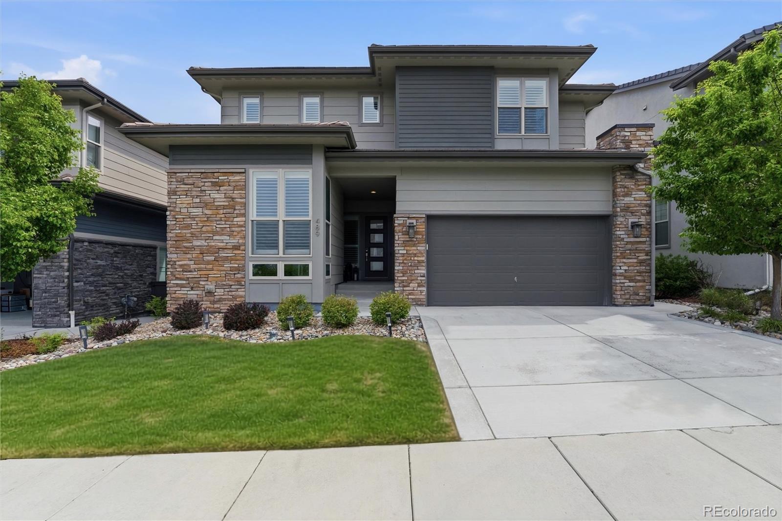 Set in beautiful BackCountry, this updated home offers a blend of luxury, comfort, & Colorado lifestyle. Framed by views & filled with natural light, the thoughtfully designed floor plan spans three finished levels with inviting spaces for living & entertaining. Just off the entry, a private study creates the ideal work-from-home retreat, while the dramatic two-story great room opens seamlessly to the kitchen & dining areas. Warm wood flooring, expansive windows, & a cozy gas fireplace bring warmth & style throughout the main level. Designed for gathering, the kitchen features an oversized island, walk-in pantry, butler’s pantry with beverage fridge, & generous prep space. Large sliding glass doors extend the living area onto the covered deck, creating effortless indoor-outdoor living with space to dine & entertain. Upstairs, the spacious primary suite offers a peaceful retreat with a spa-inspired five-piece bath with soaking tub, dual vanities, & a large walk-in closet. Two additional bedrooms, including one with an en-suite bath, a generous bonus room with French doors, full bath & laundry complete the upper level. The finished walkout basement offers large rec room, wet bar, guest suite, bath & flexible bonus spaces plus direct access to the covered patio & backyard. Beyond the home, BackCountry offers an unmatched lifestyle centered around connection, recreation, & the outdoors. Residents enjoy exclusive access to the Sundial House & resort-style pool, fitness center & community events, along with miles of scenic trails, pocket parks, & open space woven throughout the community. Walking distance to neighborhood coffee shops & parks, the location encourages an active lifestyle. Enjoy access to four state-of-the-art recreation centers, extensive trail systems, sports courts, fitness programs, cultural events, & year-round organized activities. With 4 bedrooms, 5 bathrooms, & exceptional community amenities, this home won’t disappoint.